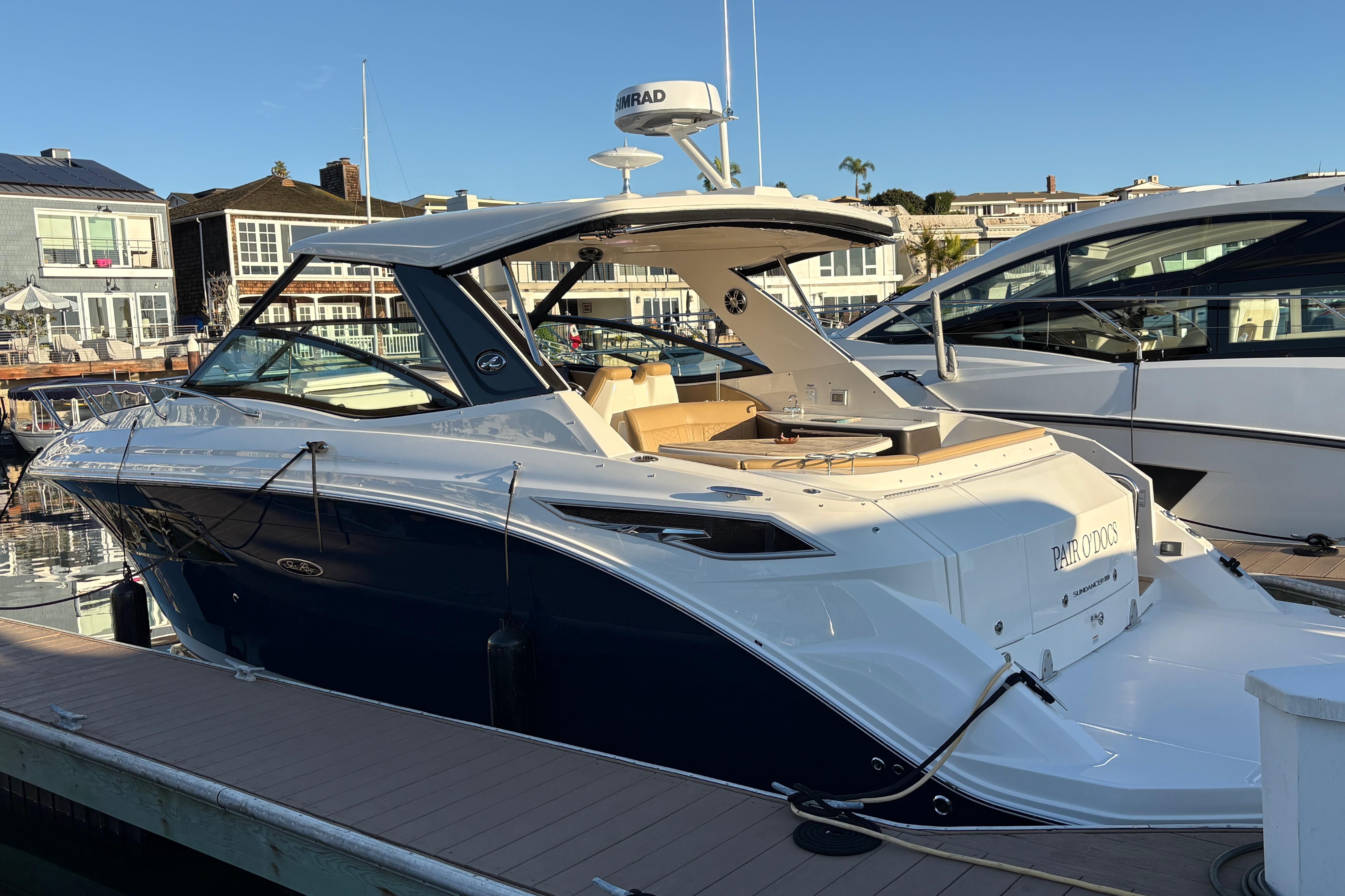 2022 Sea Ray Sundancer 320 yacht docked at marina, showcasing sleek design and luxury features.