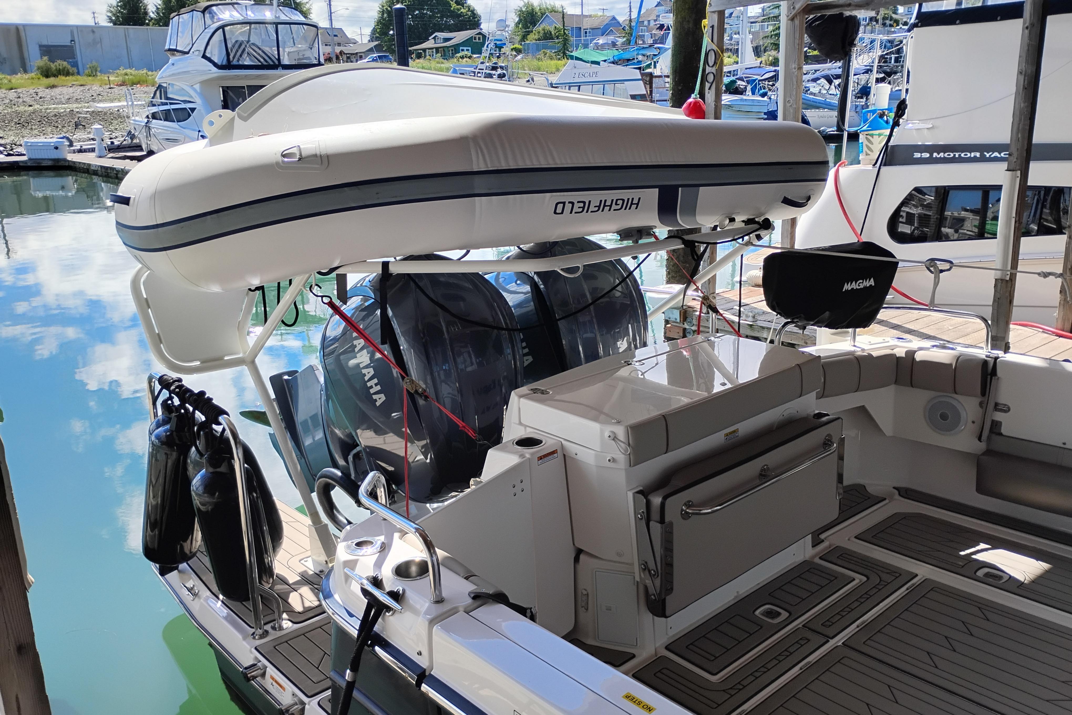2022 Cutwater C-32 Coupe docked, featuring Yamaha engines and a Highfield inflatable boat.