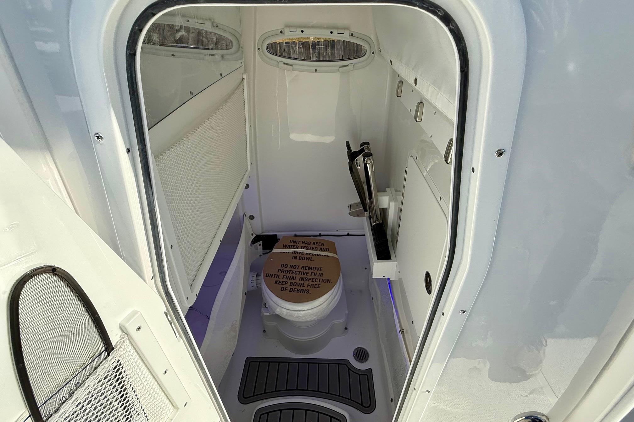 Interior of 2026 Sea Hunt Ultra 275 Coffin Box boat's compact bathroom.