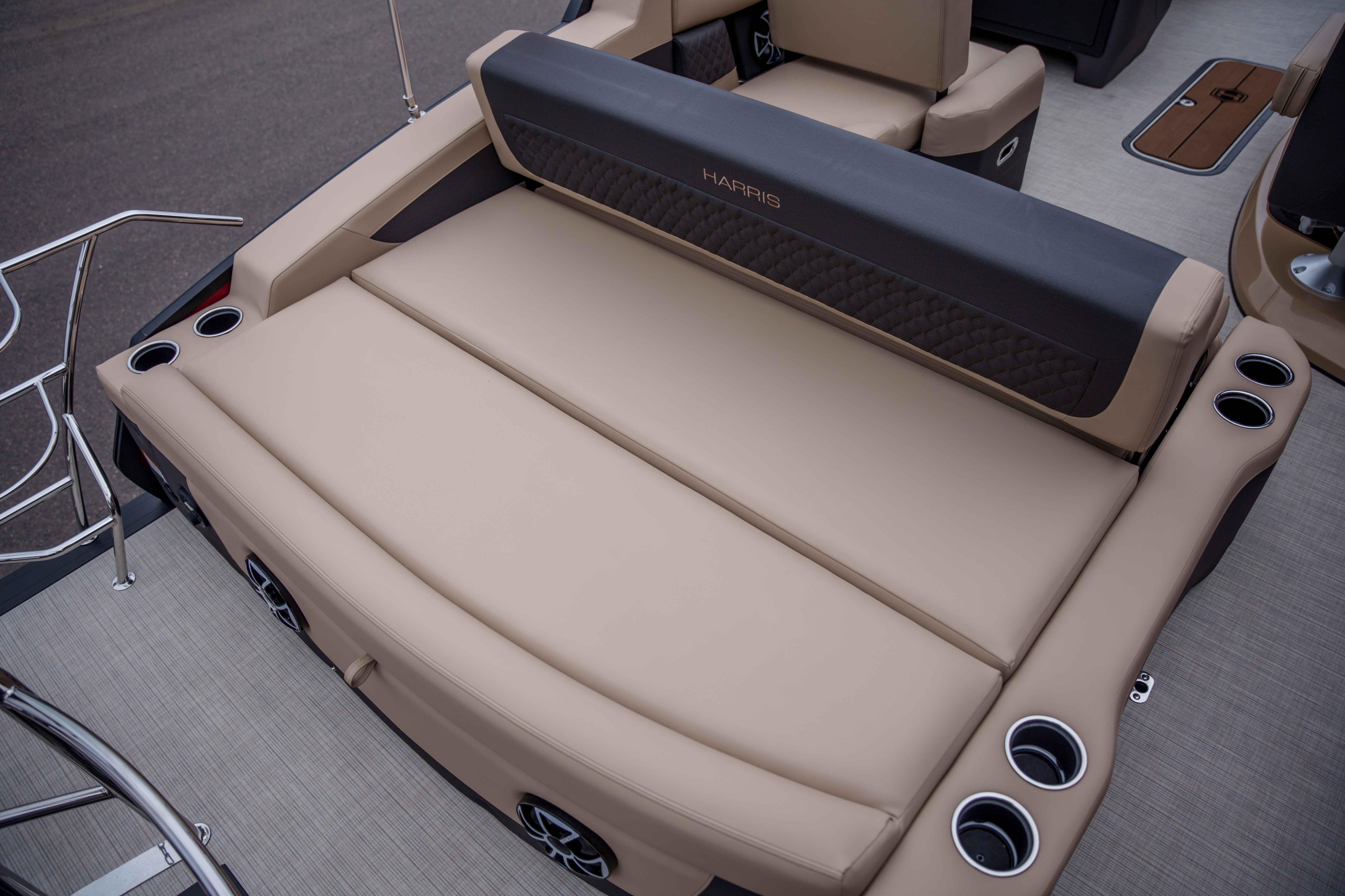 Luxurious seating on 2026 Harris Sunliner 230 boat with cup holders and elegant design.