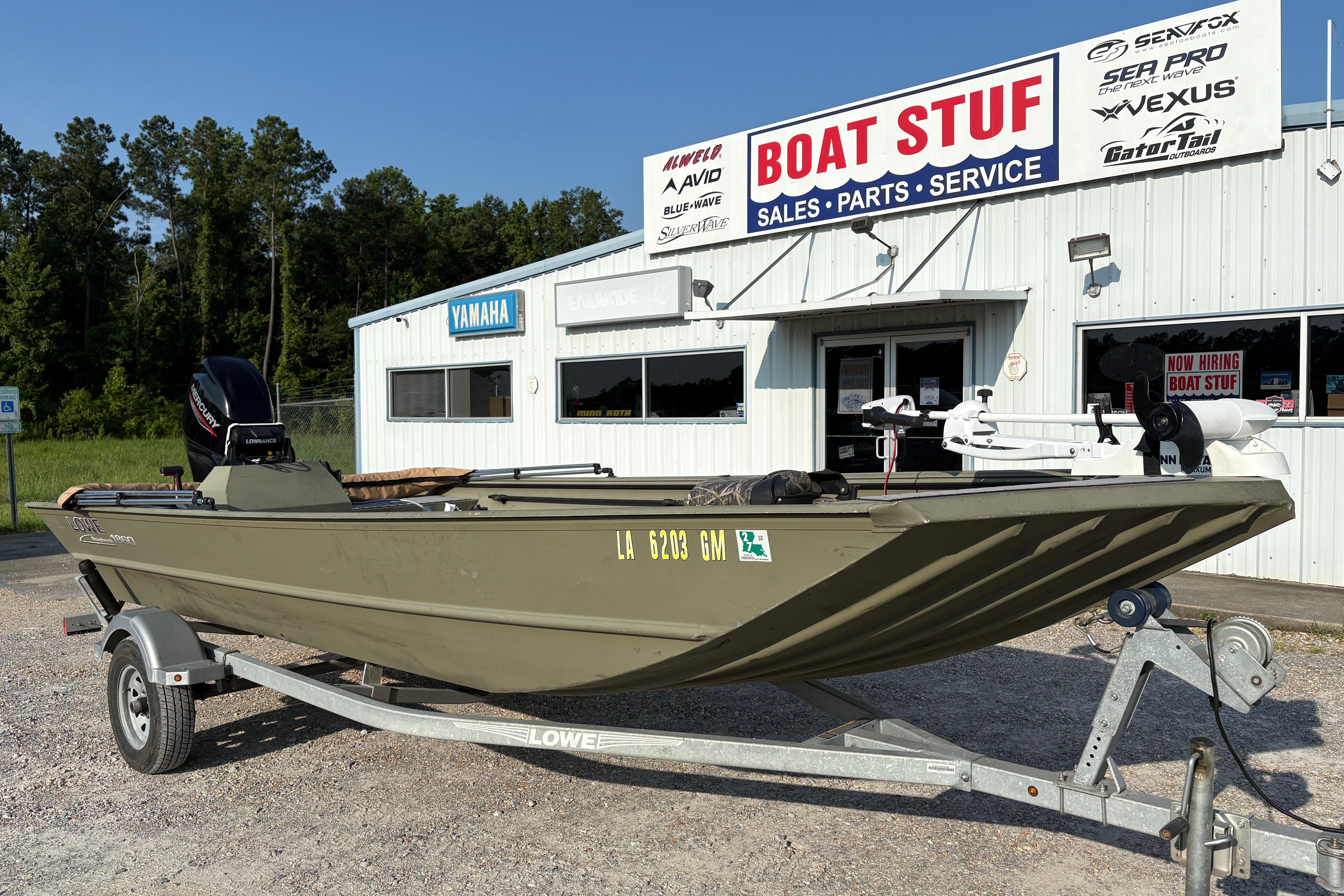 2019 Lowe Roughneck 1860SC boat on trailer outside dealership.