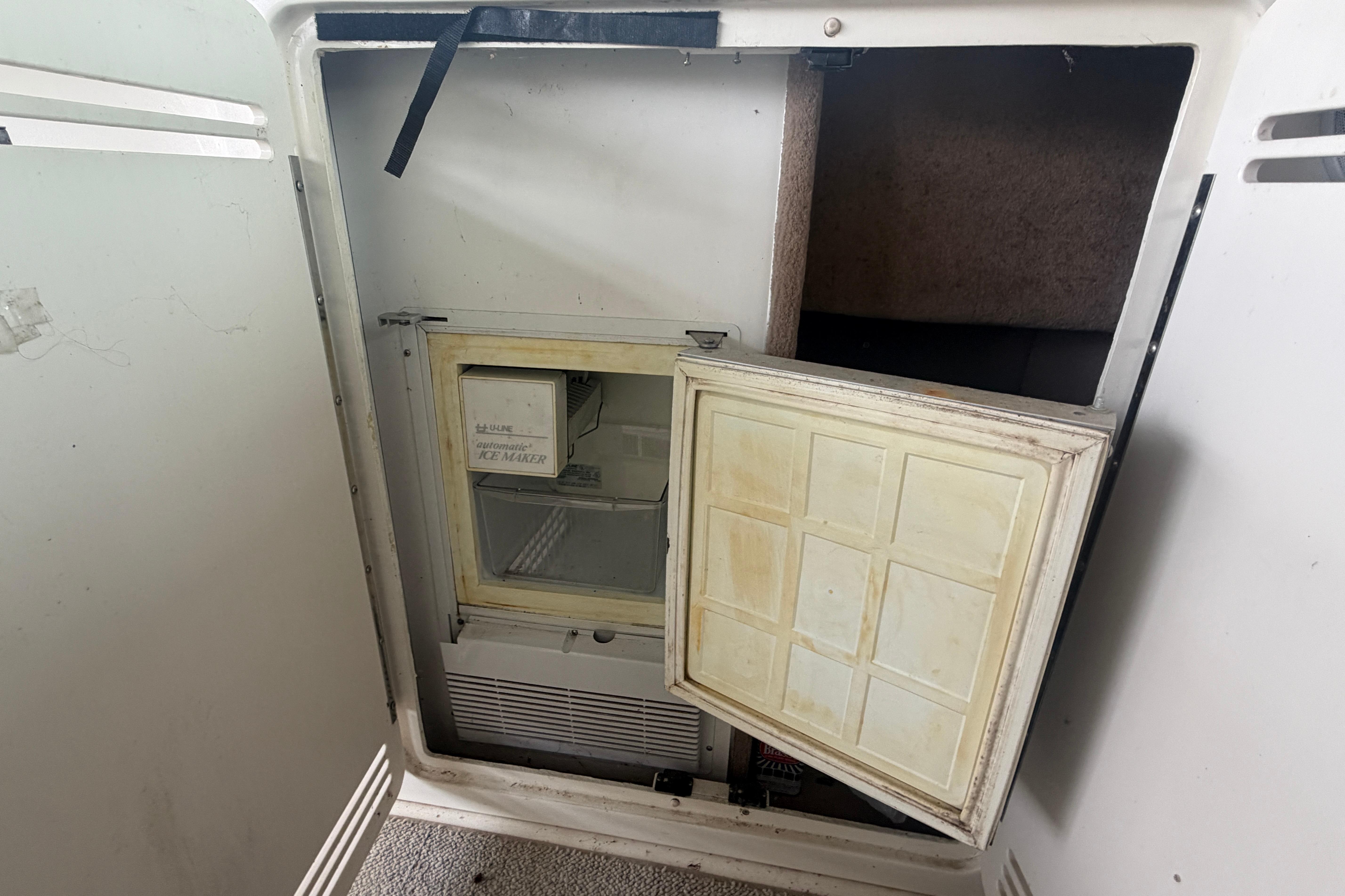 1999 Sea Ray 400 Sundancer ice maker with open door, showing interior details.