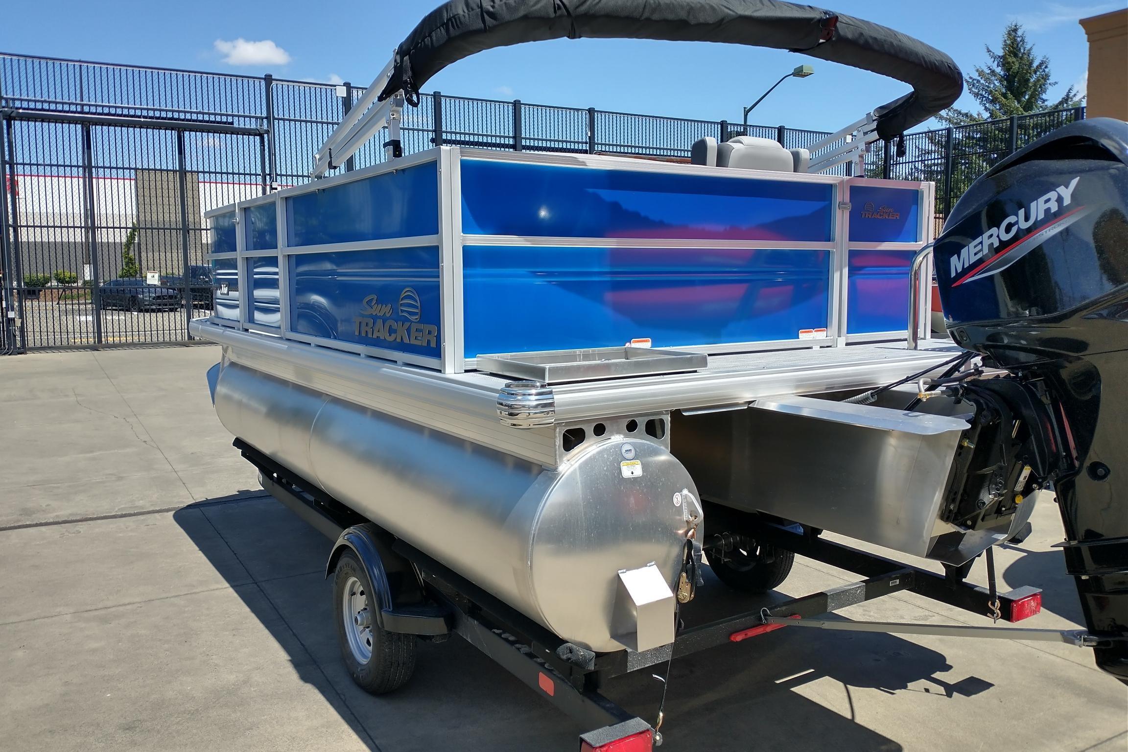 2026 Sun Tracker Party Barge 16 DLX pontoon boat with Mercury engine on trailer.