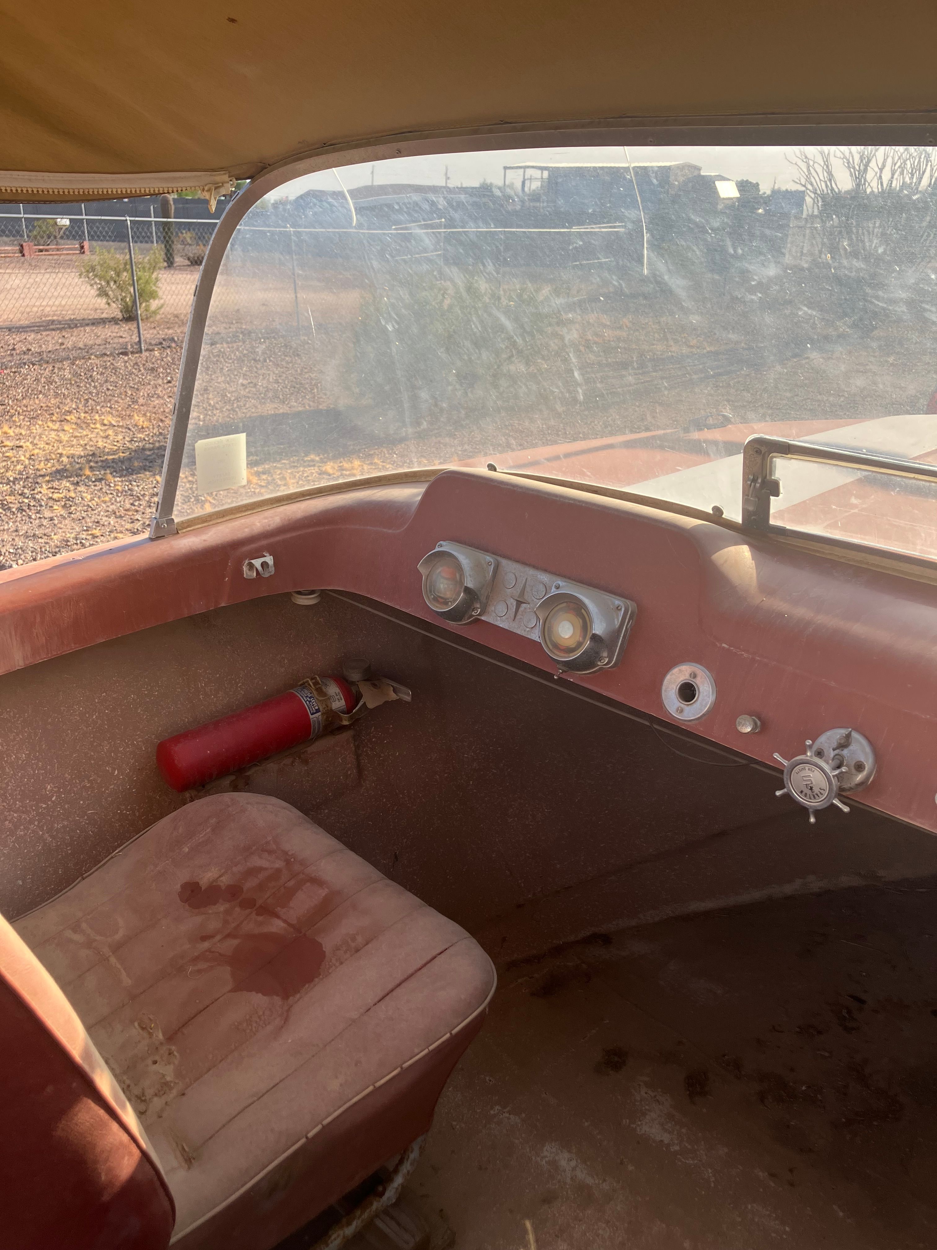 The image shows the cockpit of a 1958 Hydroswift Runabout with a fire extinguisher.