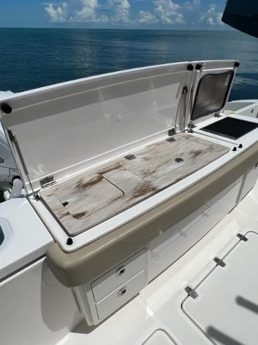 2019 Pursuit S 408 Sport boat with open storage compartment on deck.