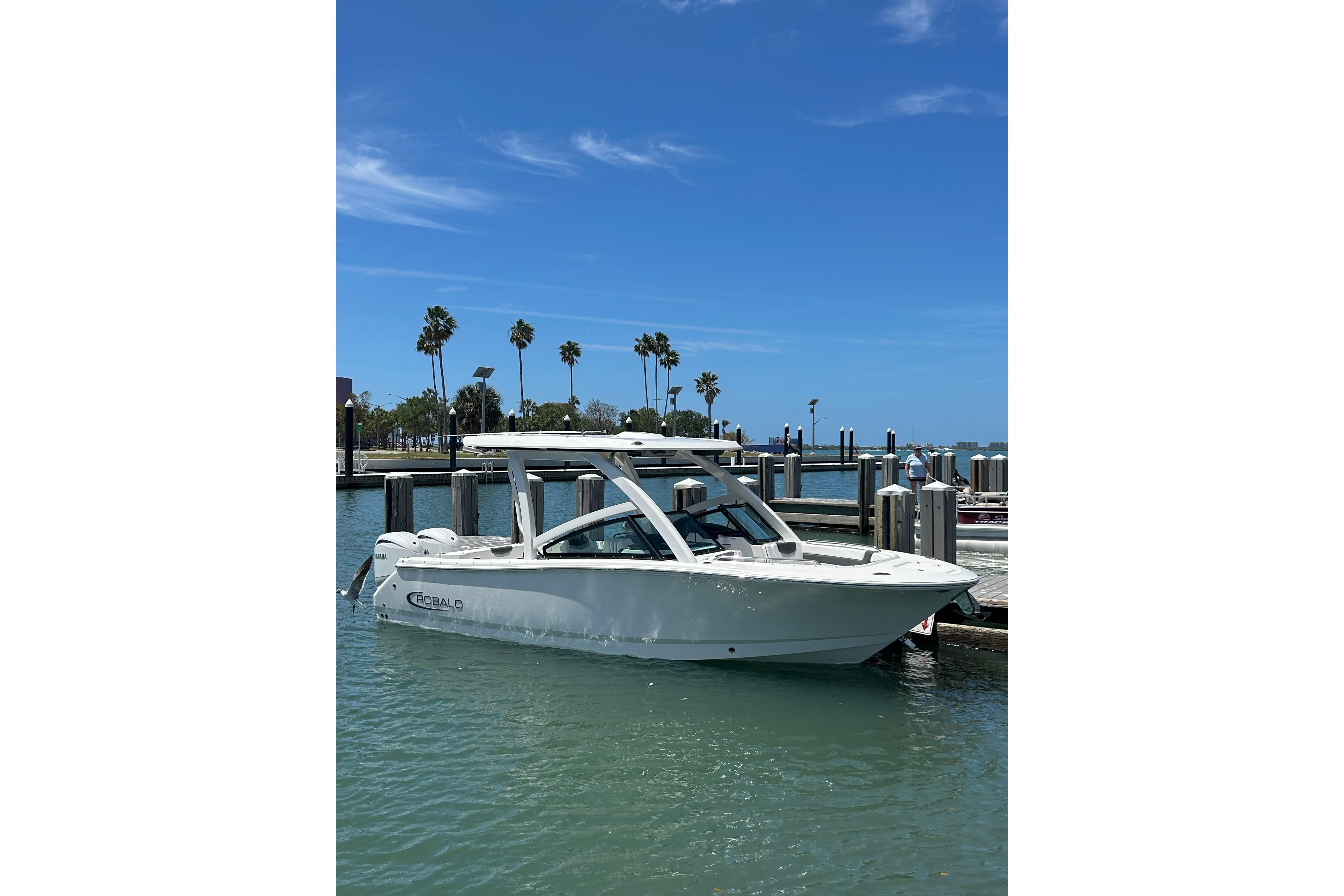2026 Robalo R257 Dual Console boat docked in sunny marina.