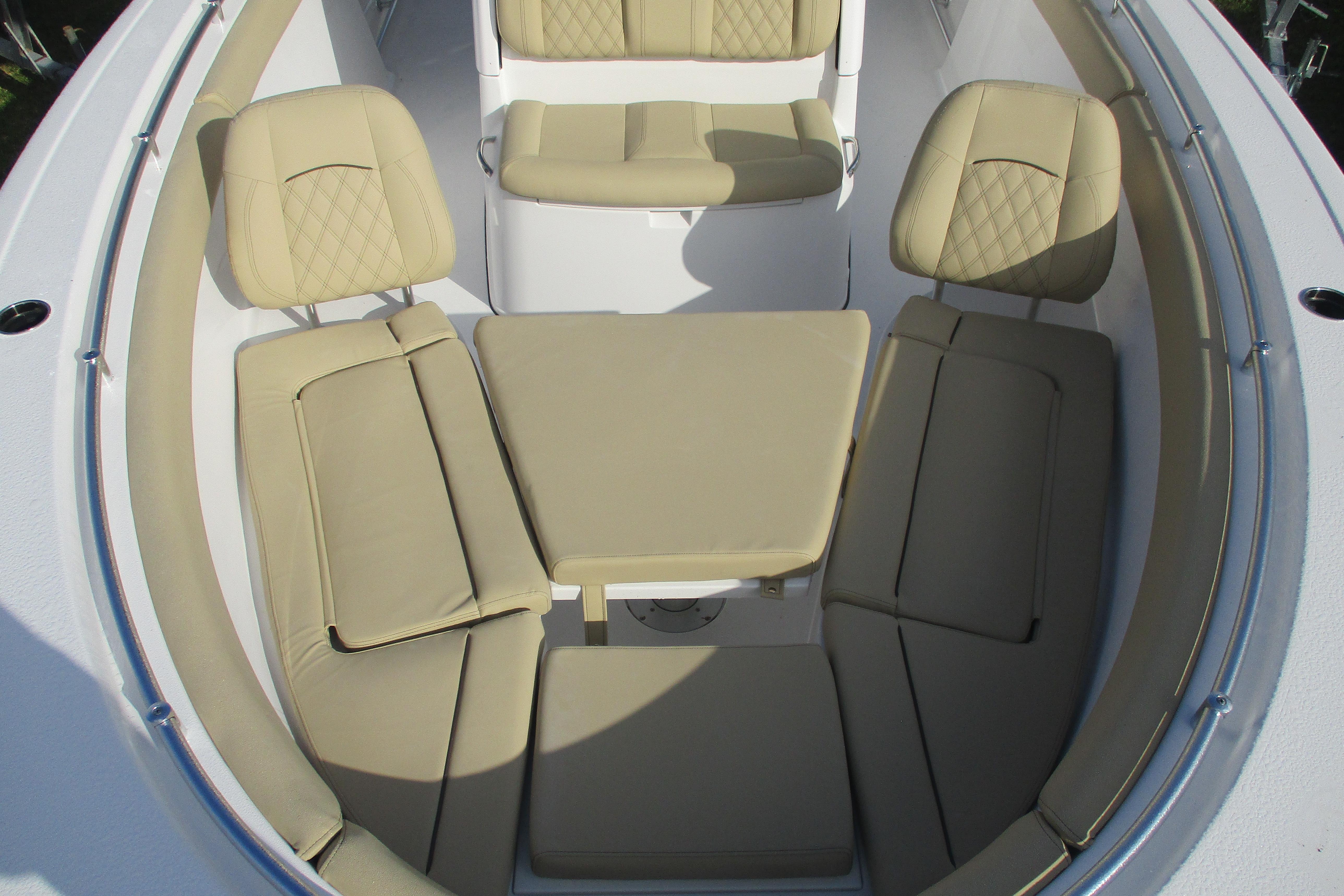 2026 Sportsman Open 302 Center Console with beige cushioned seating arrangement.