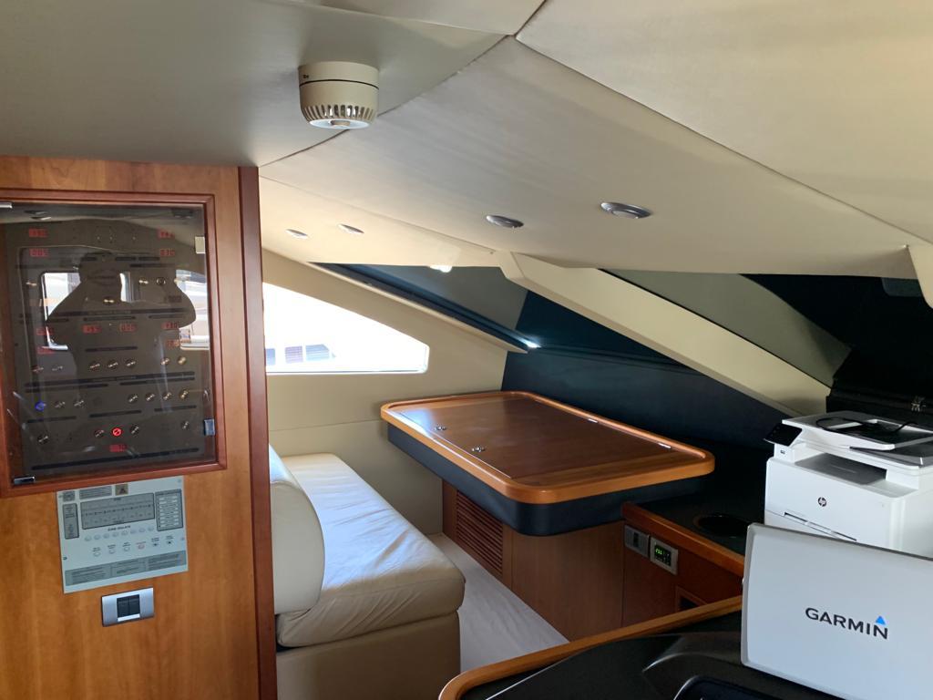 Interior of 2006 Sunseeker 90 Yacht with seating, table, and Garmin equipment.