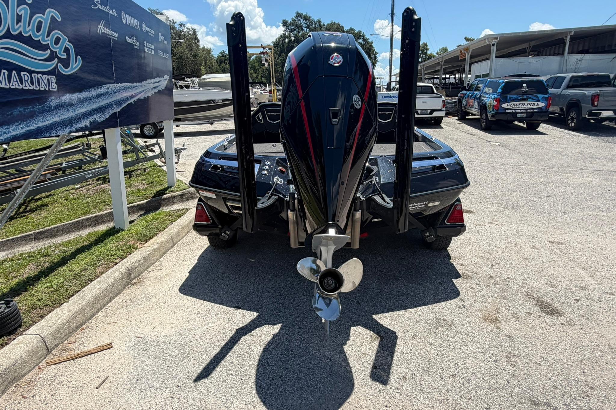2023 Ranger Z521R boat with powerful outboard motor, parked at a marina.