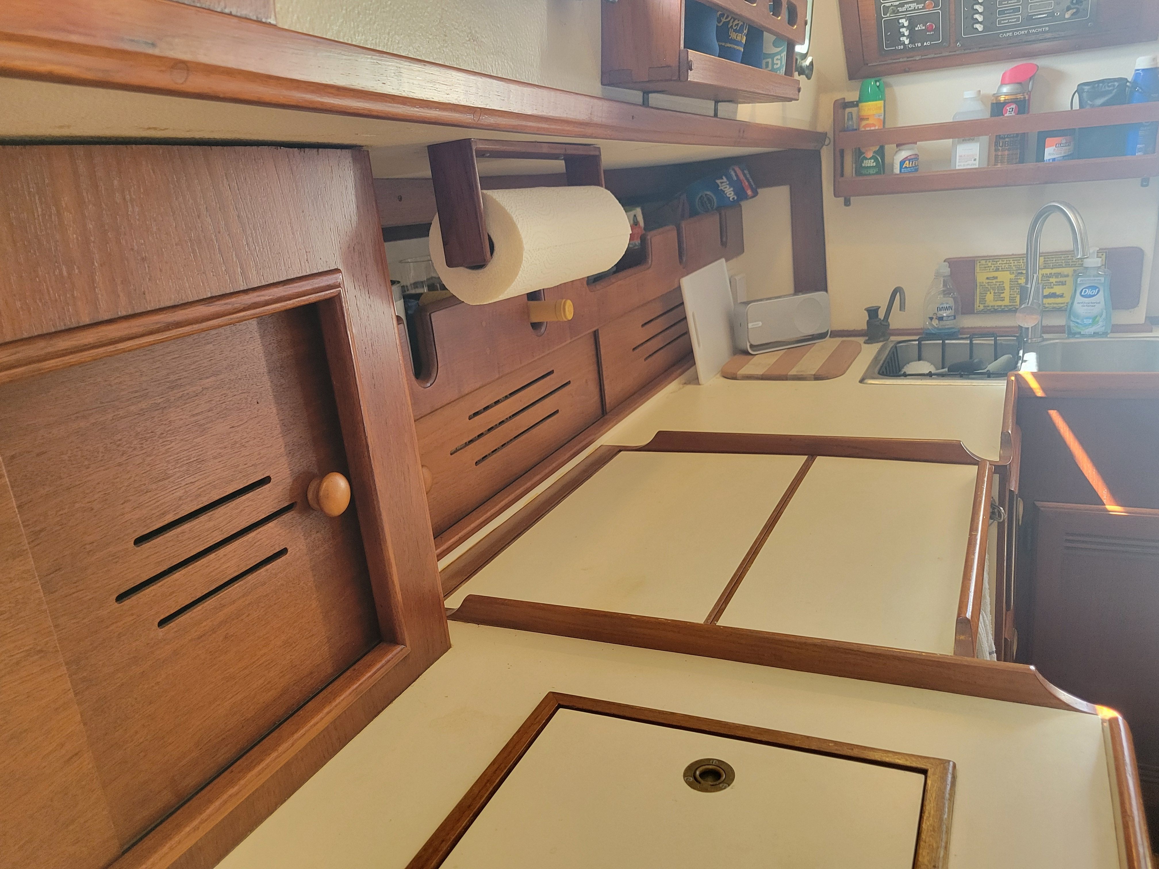 Interior view of a 1989 Cape Dory MS300 with wooden cabinets and a small sink.