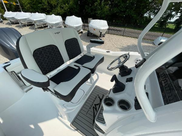 2025 Tidewater 232 CC Adventure boat interior with dual seating and steering console.