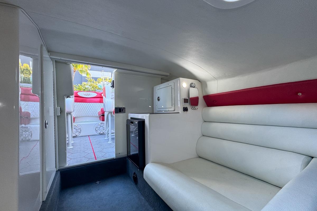 Interior of 2022 Velocity 290sc boat with white seating and compact cabin design.