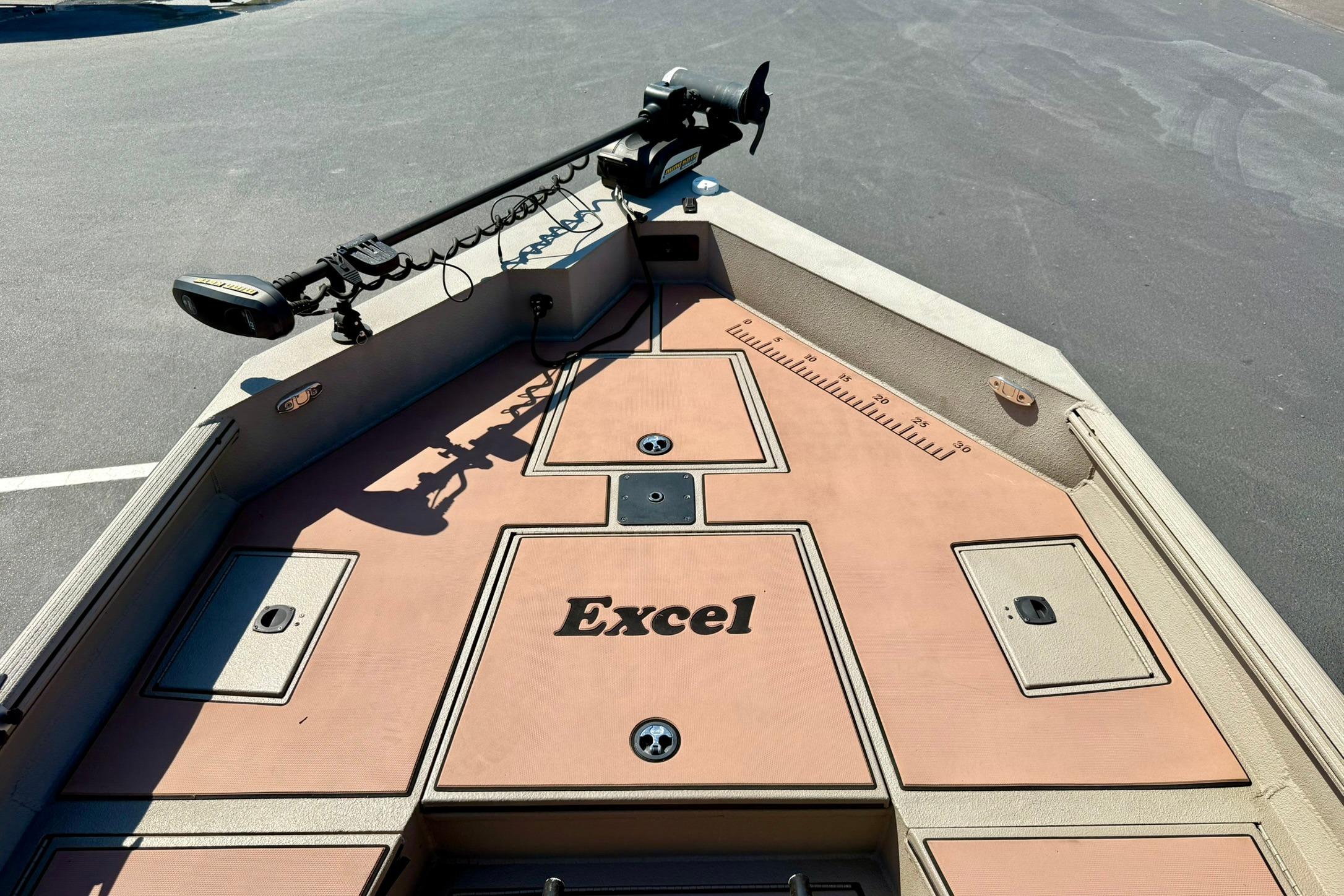 2019 Excel 230 Bay Pro boat deck with storage compartments and trolling motor.