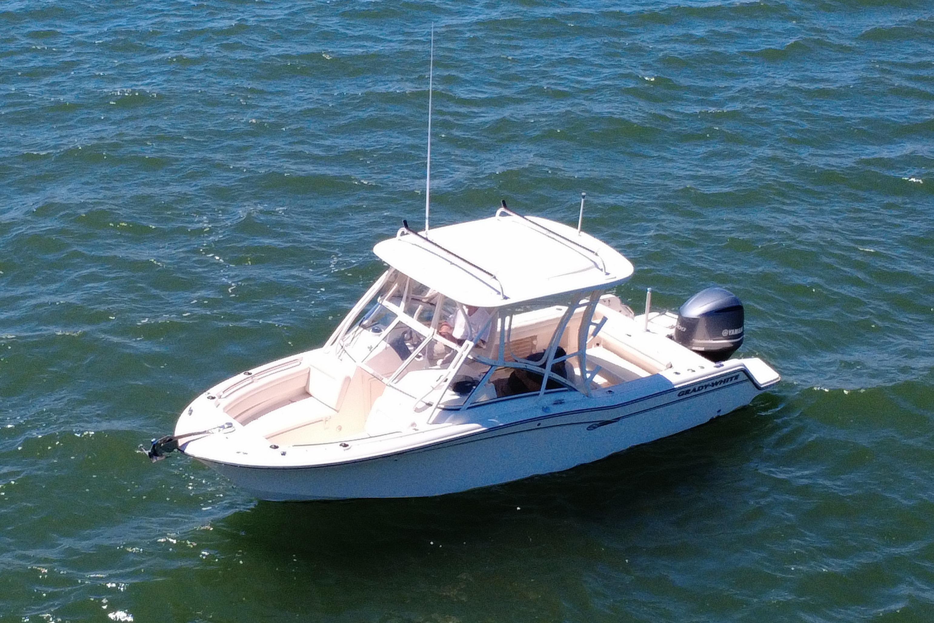 2017 Grady-White Freedom 235 boat on open water, featuring sleek design and Yamaha engine.