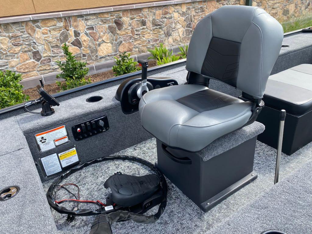 2025 Tracker Panfish 17 boat interior with gray seating and control panel.
