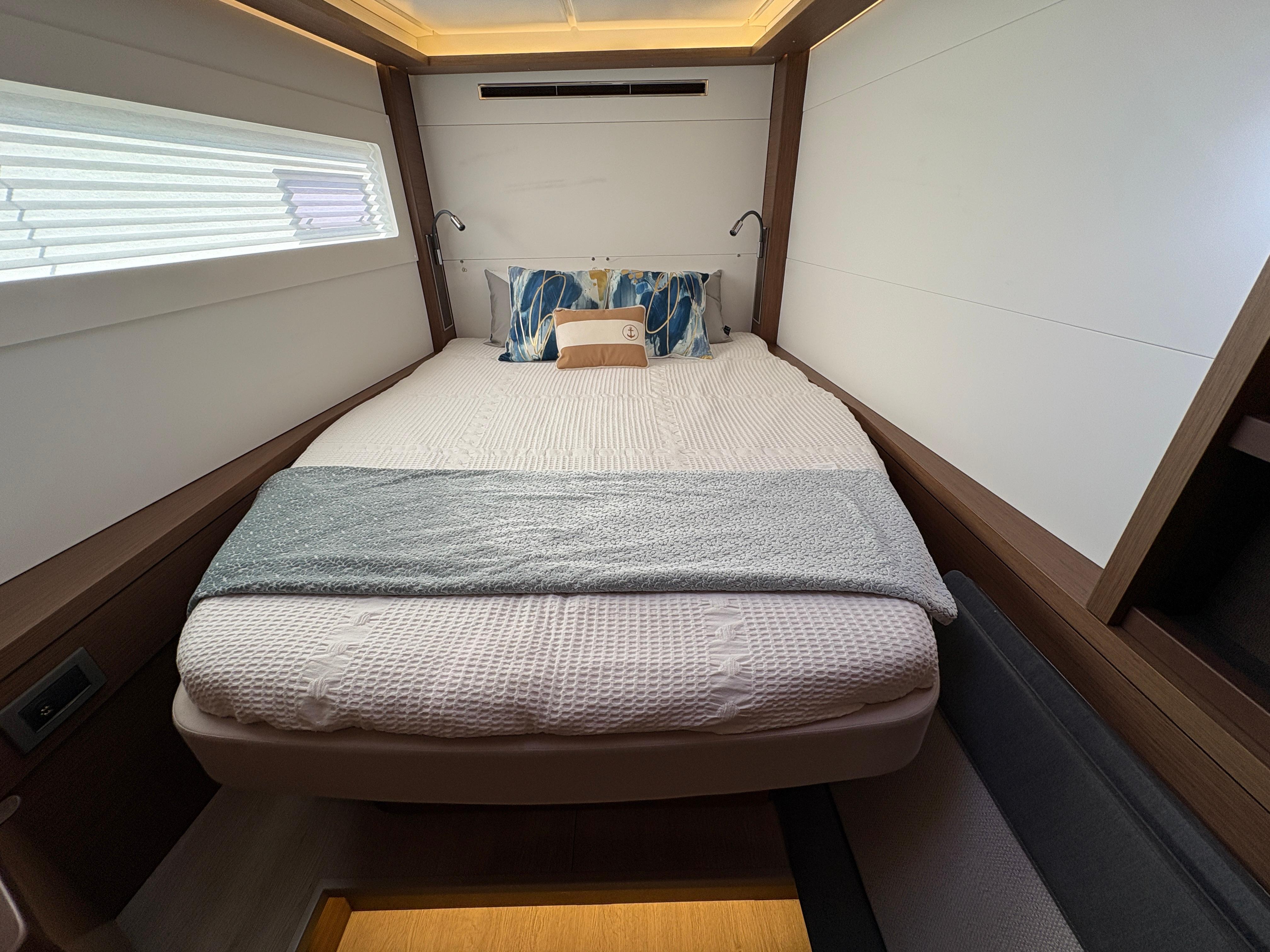 Luxurious cabin interior of 2018 Dufour 560 Exclusive yacht with cozy bedding.