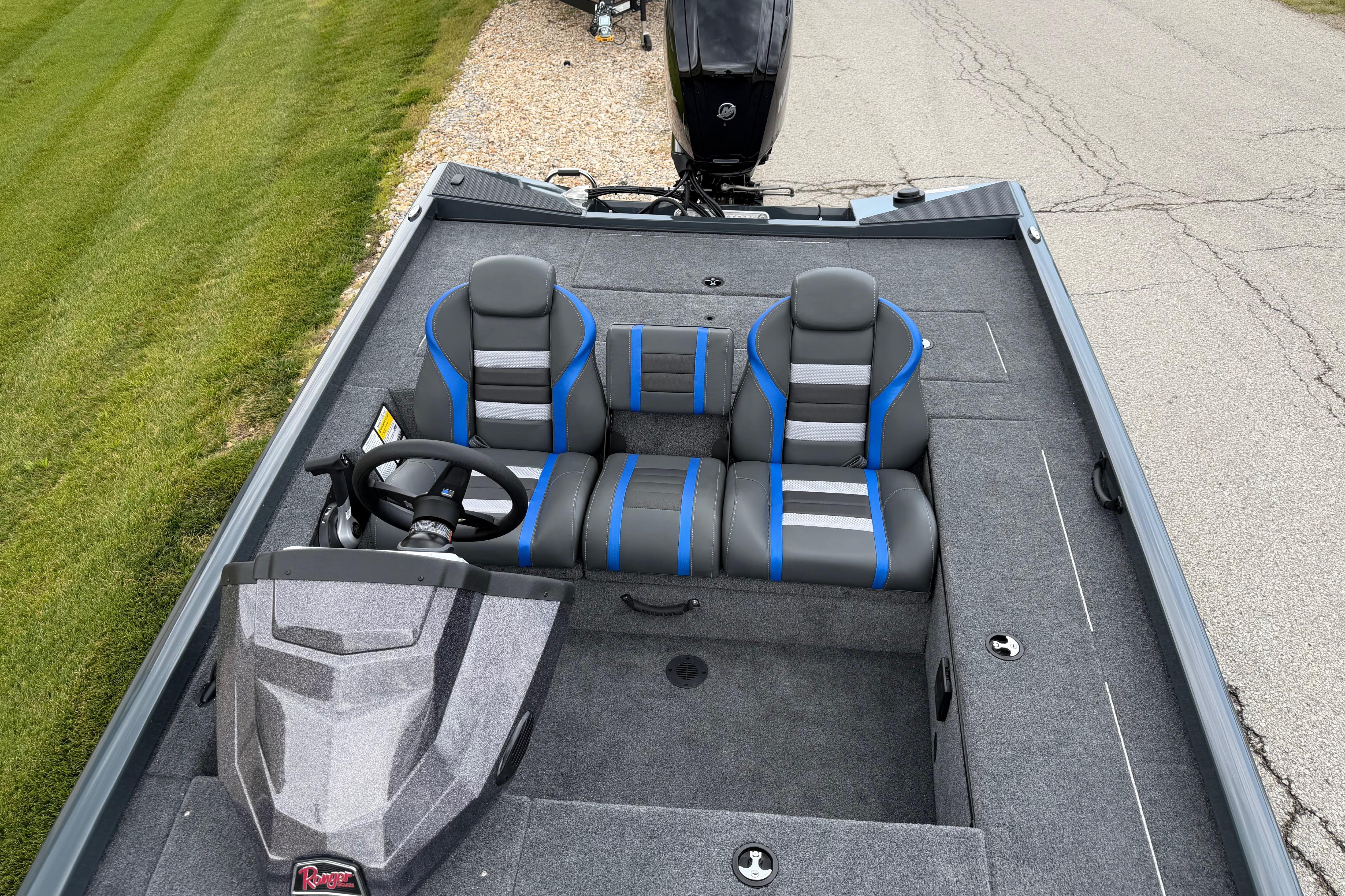 2026 Ranger RT178C boat interior with dual seats and steering wheel, parked on pavement.