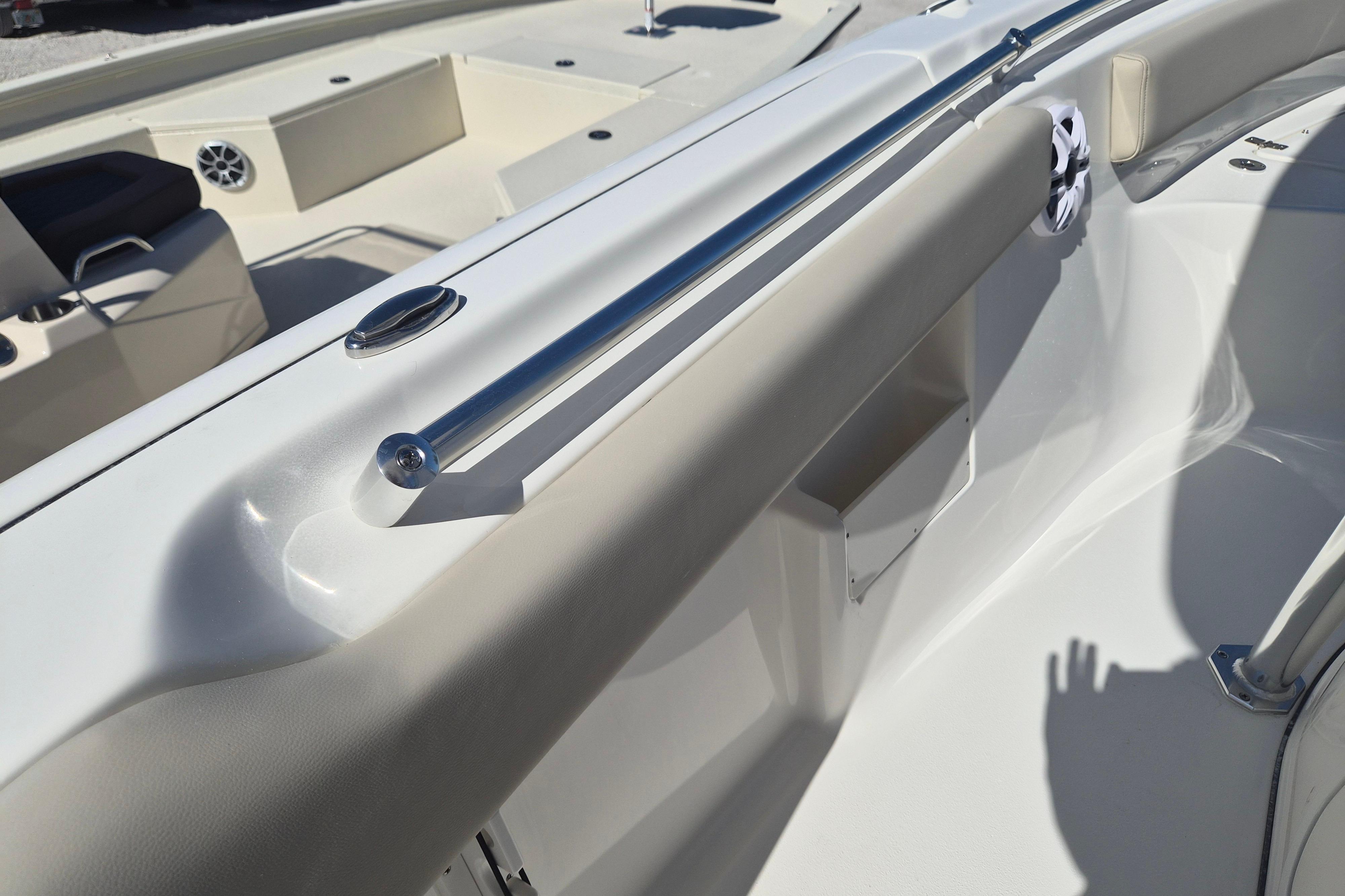 Interior view of 2026 Key West 239 FS boat, featuring sleek seating and stainless steel rail.
