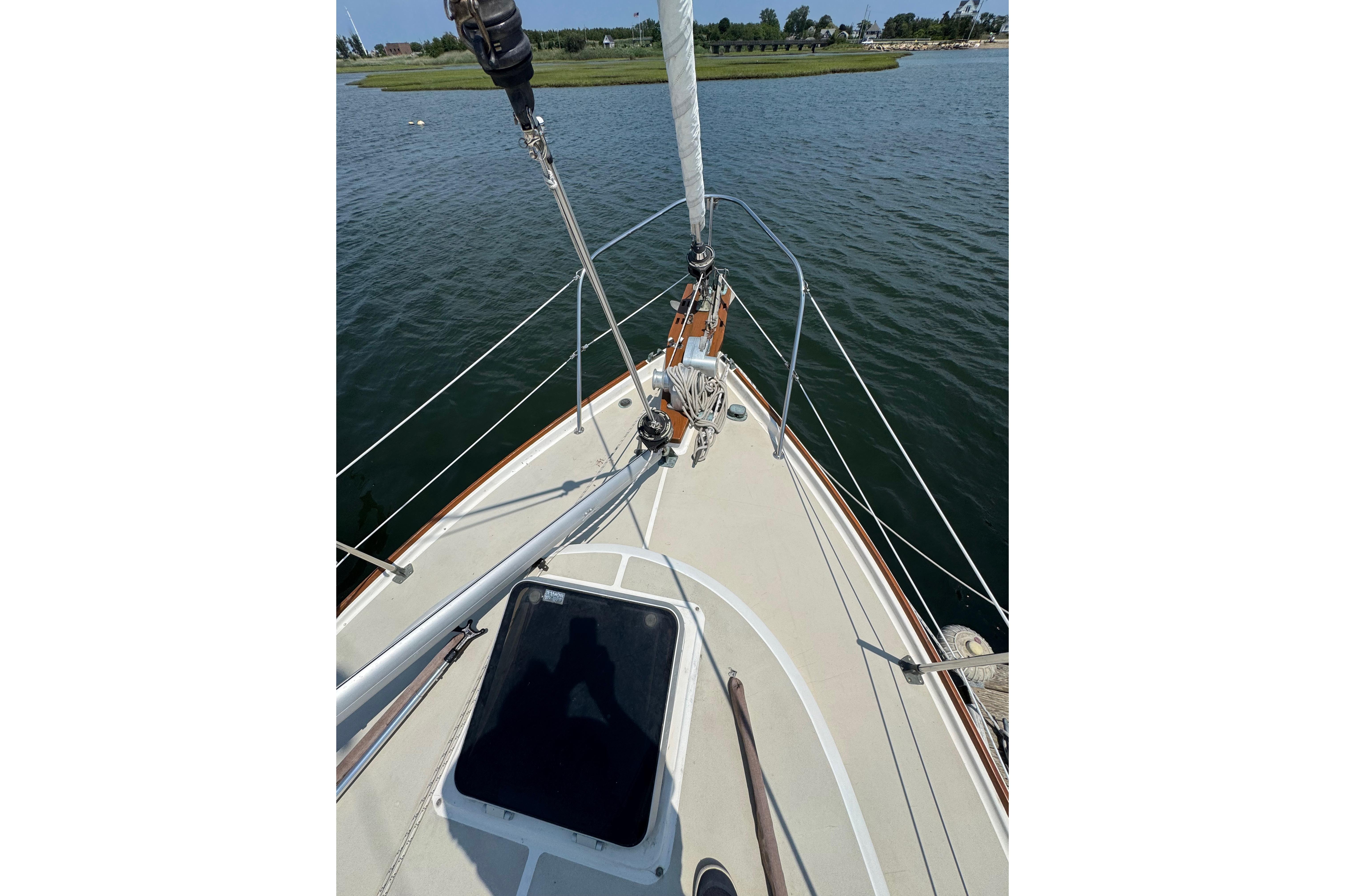 1989 Cape Dory 30 Motorsailer deck view, sailing on calm waters.