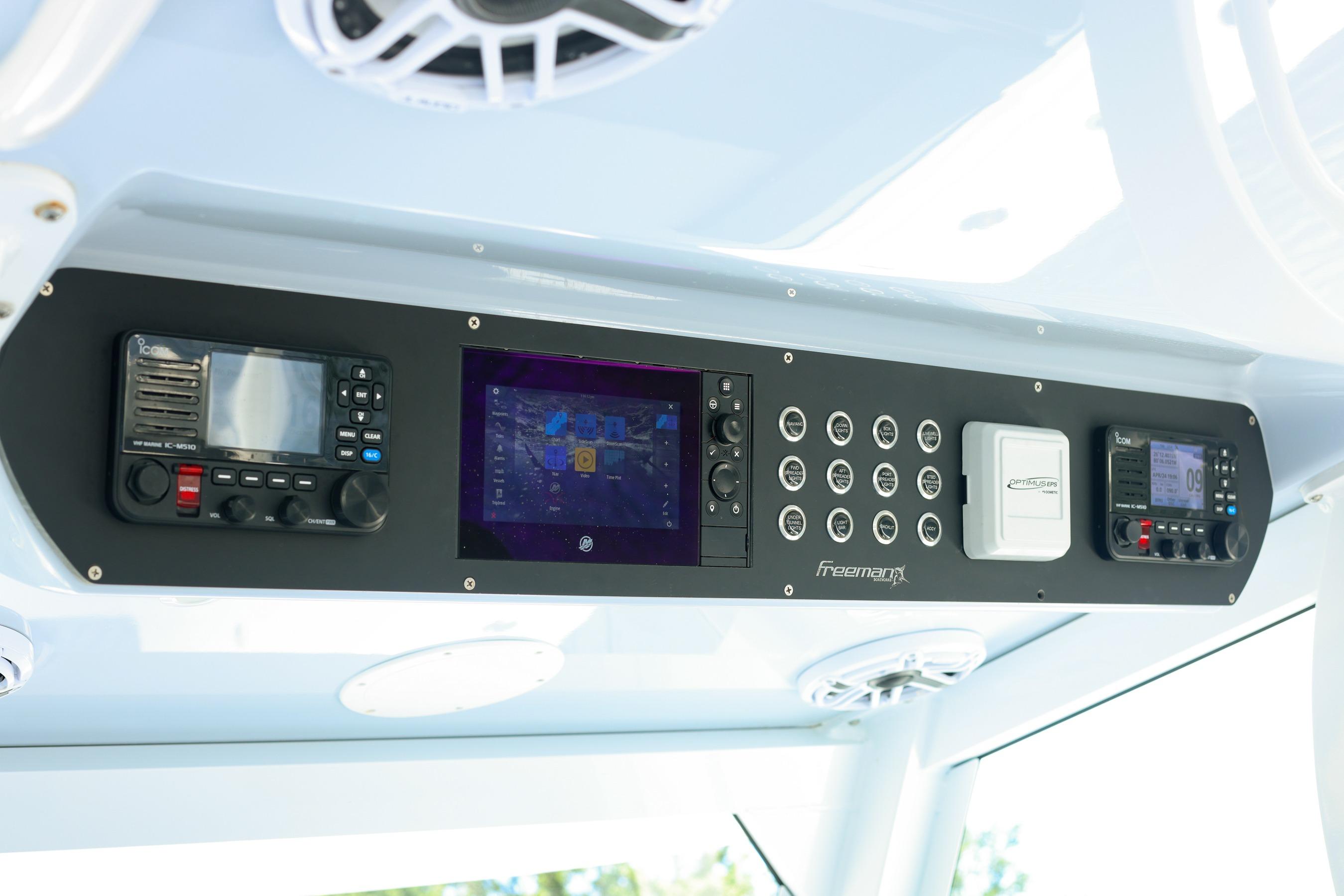 Control panel of a 2022 Freeman 47 boat with navigation and communication systems.