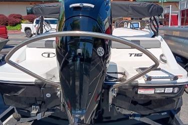 2026 Tahoe T16 boat, rear view with motor and seating, parked outdoors.