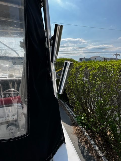 A 1998 Sport-Craft 252 SPORT FISH with fishing rod holders and a clear sky in the background.