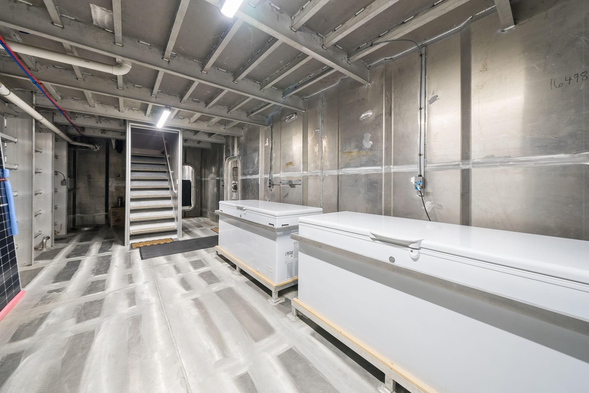 Industrial interior of Breaux Brothers 120 GLV vessel, featuring freezers and metal stairs, 2025 model.