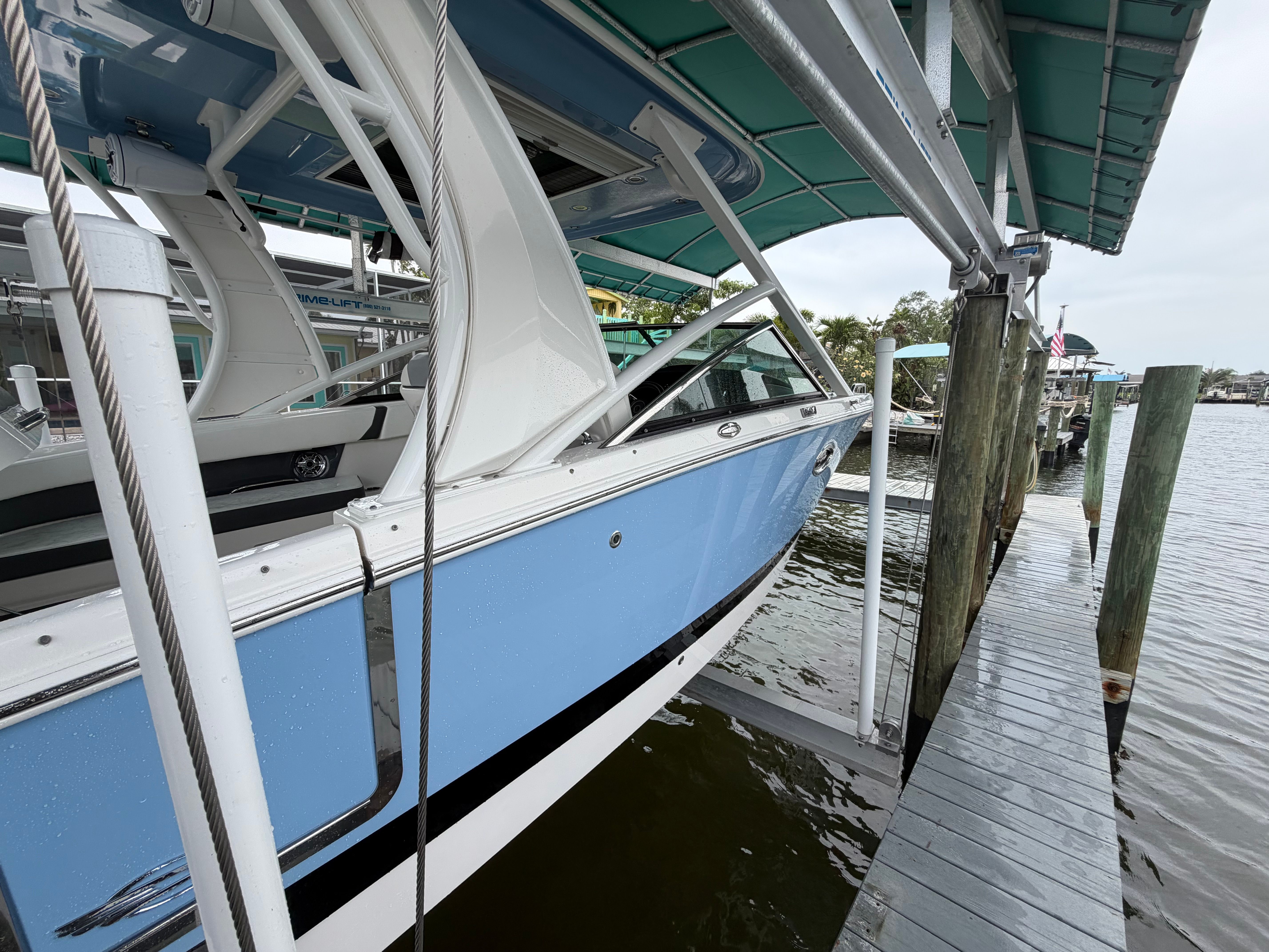 A blue and white boat docked at a harbor pier.