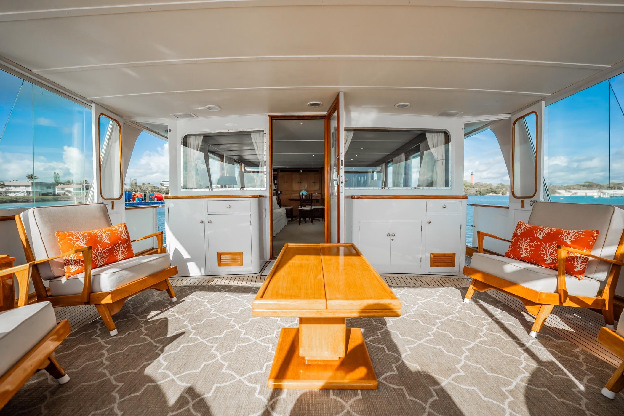 Luxurious 1972 Trumpy 72 Motor Yacht deck with elegant seating and scenic views.