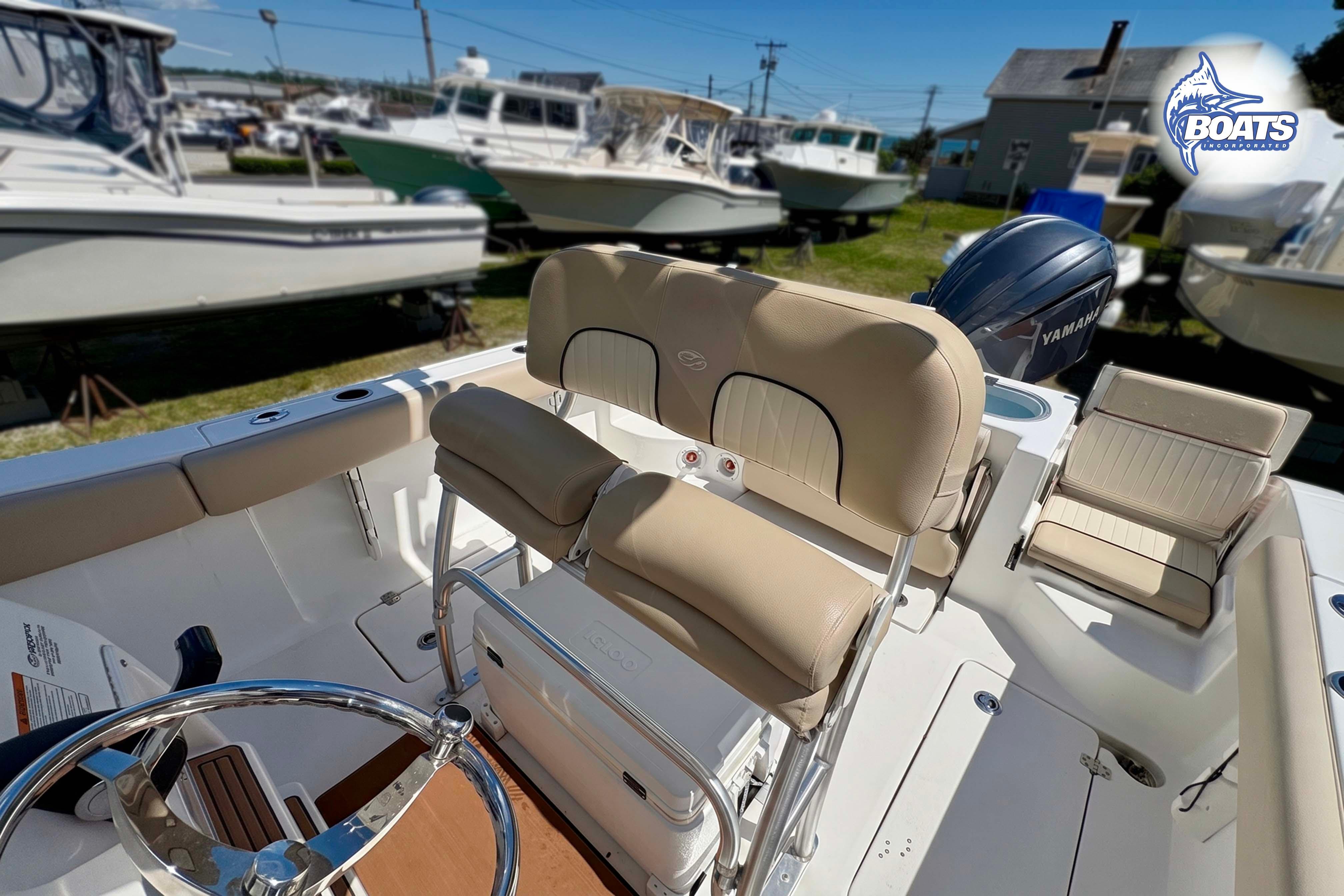 2015 Sea Fox 266 Commander boat interior with beige seating and Yamaha engine.