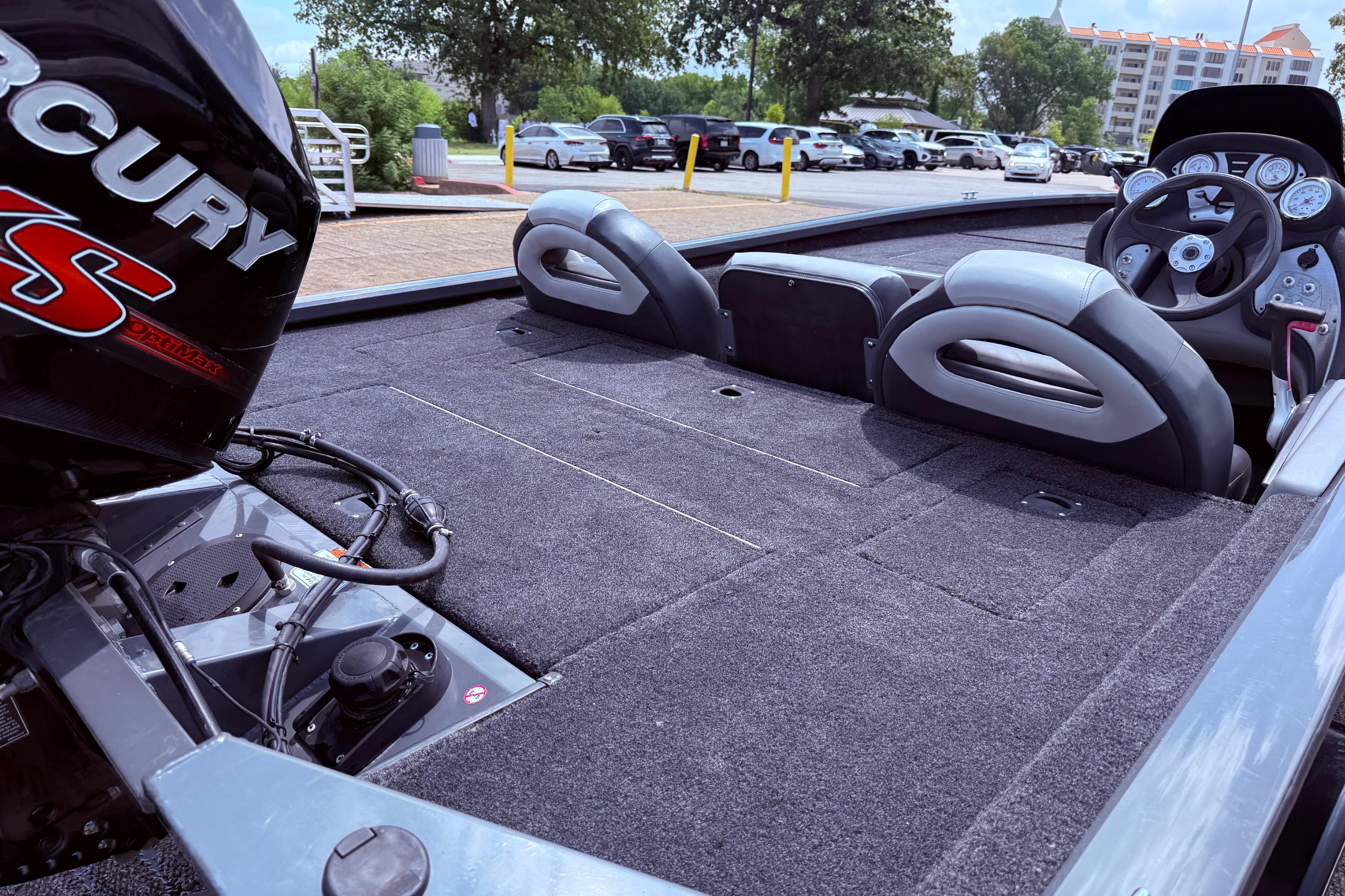 2015 Tracker Pro Team 190 TX boat interior with Mercury engine, parked outdoors.