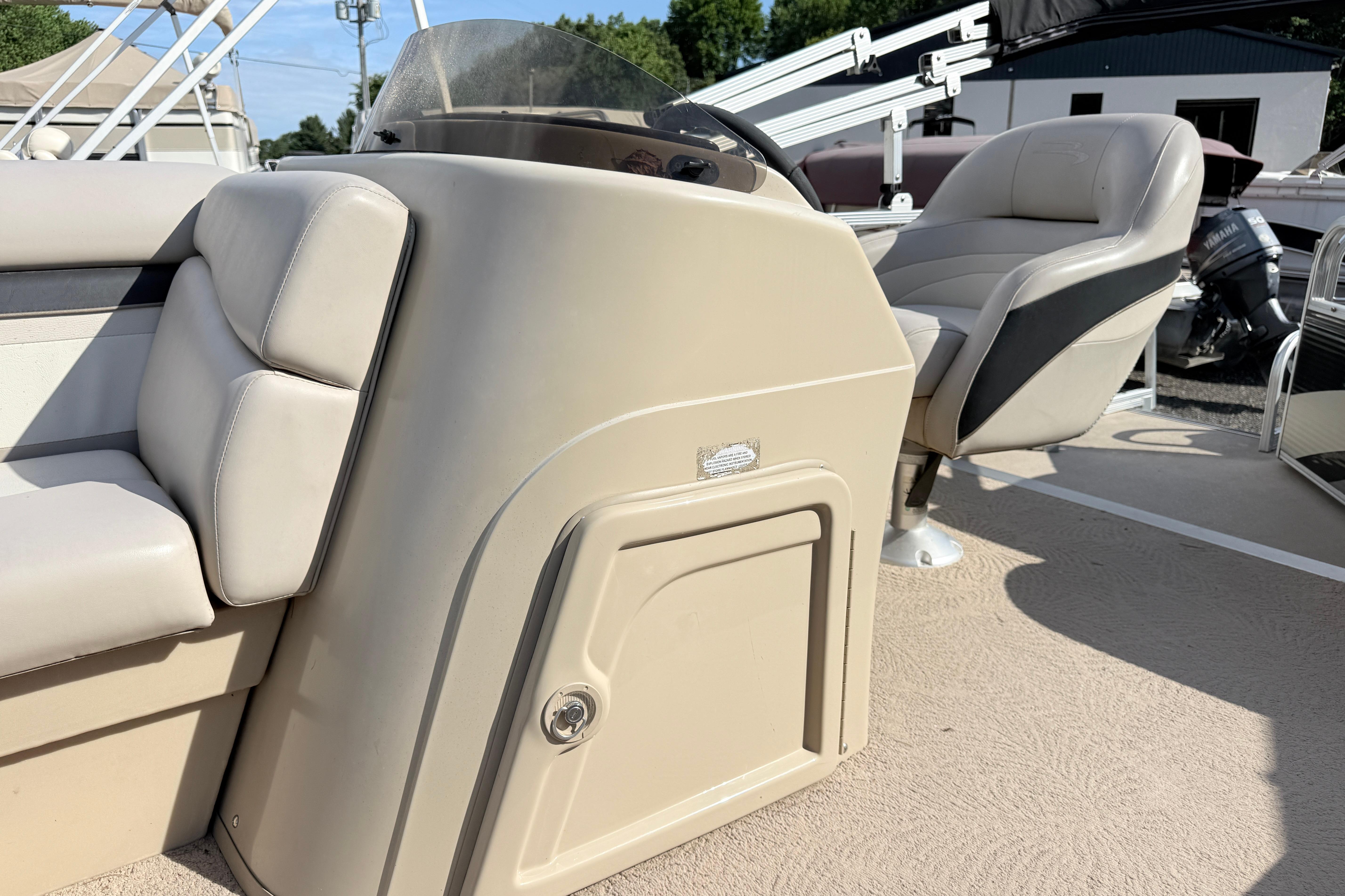 2010 Bennington 20SLi boat interior with beige seating and steering console.