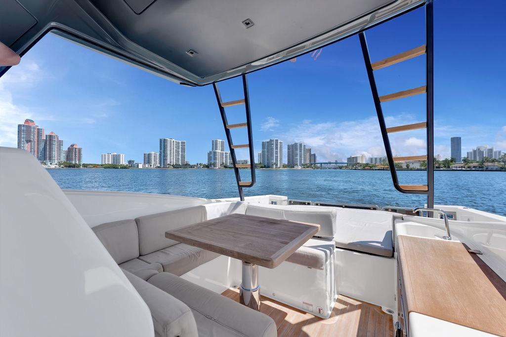 Luxurious 2021 Bluegame BG 42 yacht interior with city skyline view over water.