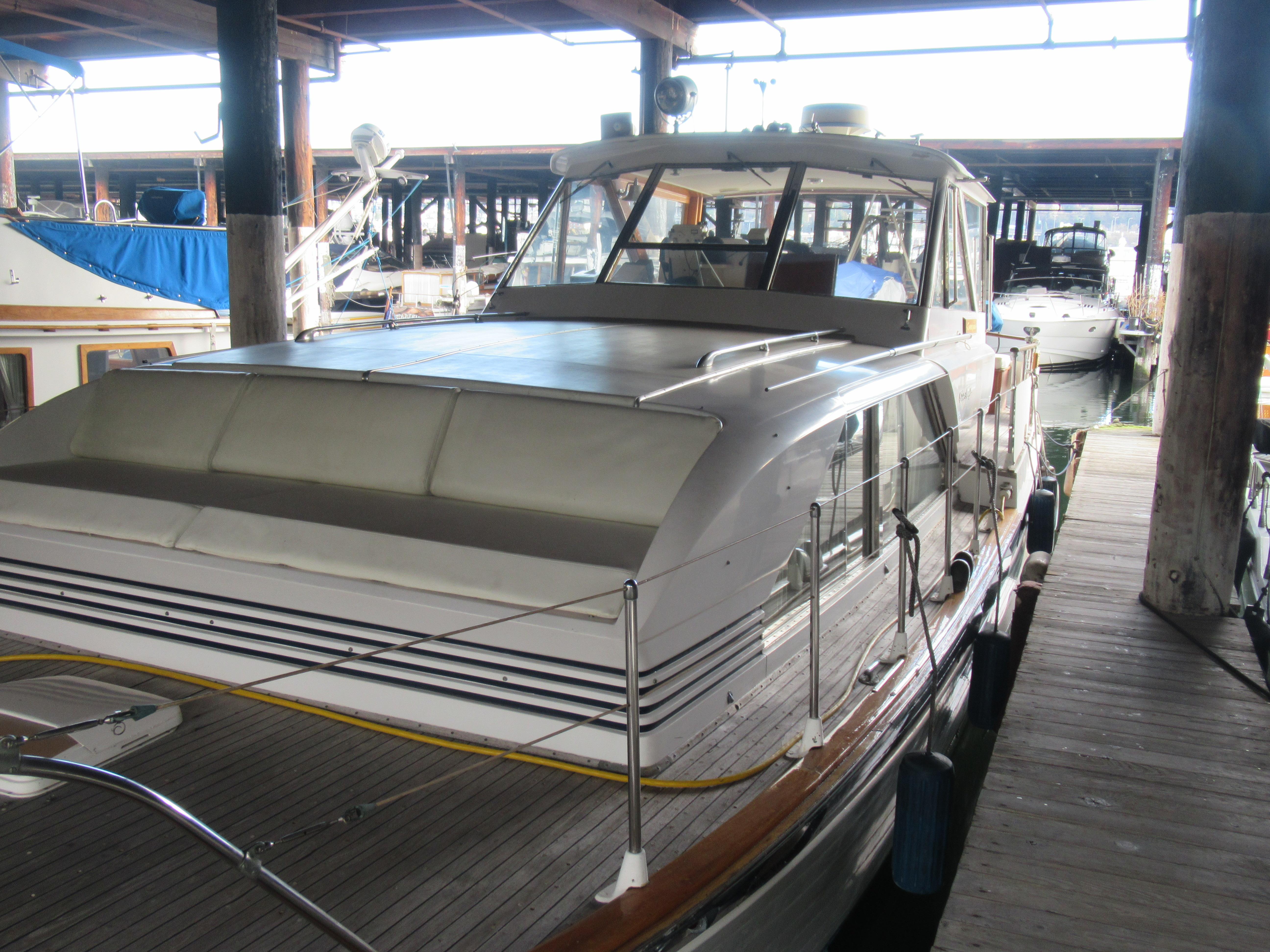 1963 Chris-Craft Constellation yacht docked in a marina, showcasing classic design and elegance.