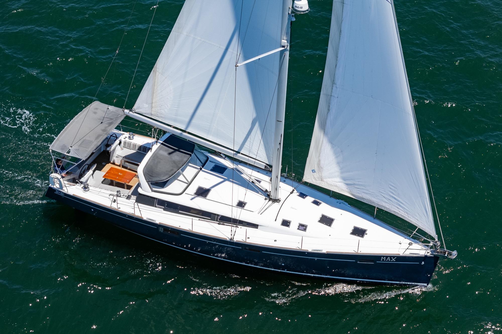 2017 Beneteau Sense 50 sailing yacht on open water, aerial view.