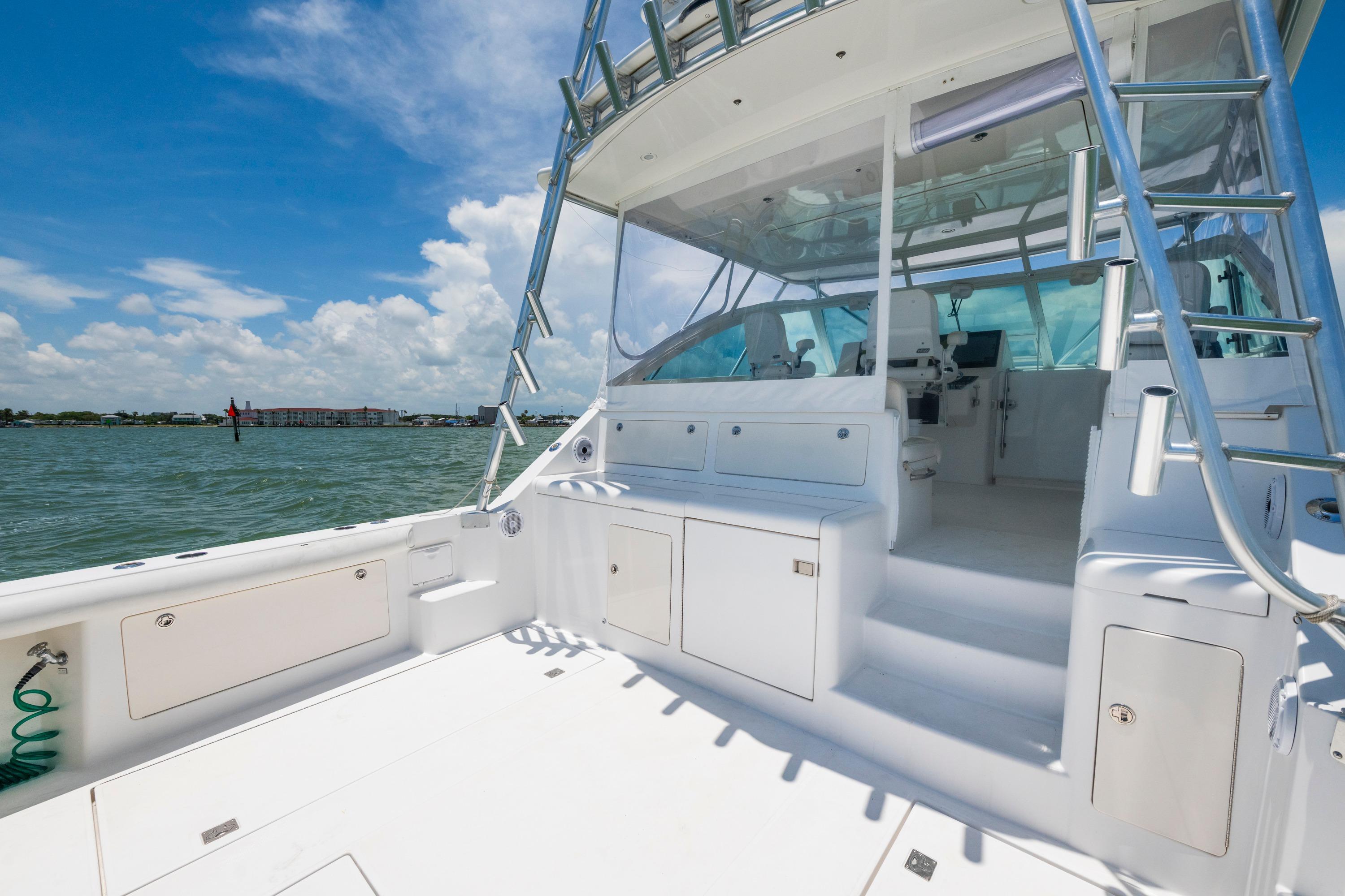 2010 Cabo 45 Express yacht interior with helm, seating, and ocean view.