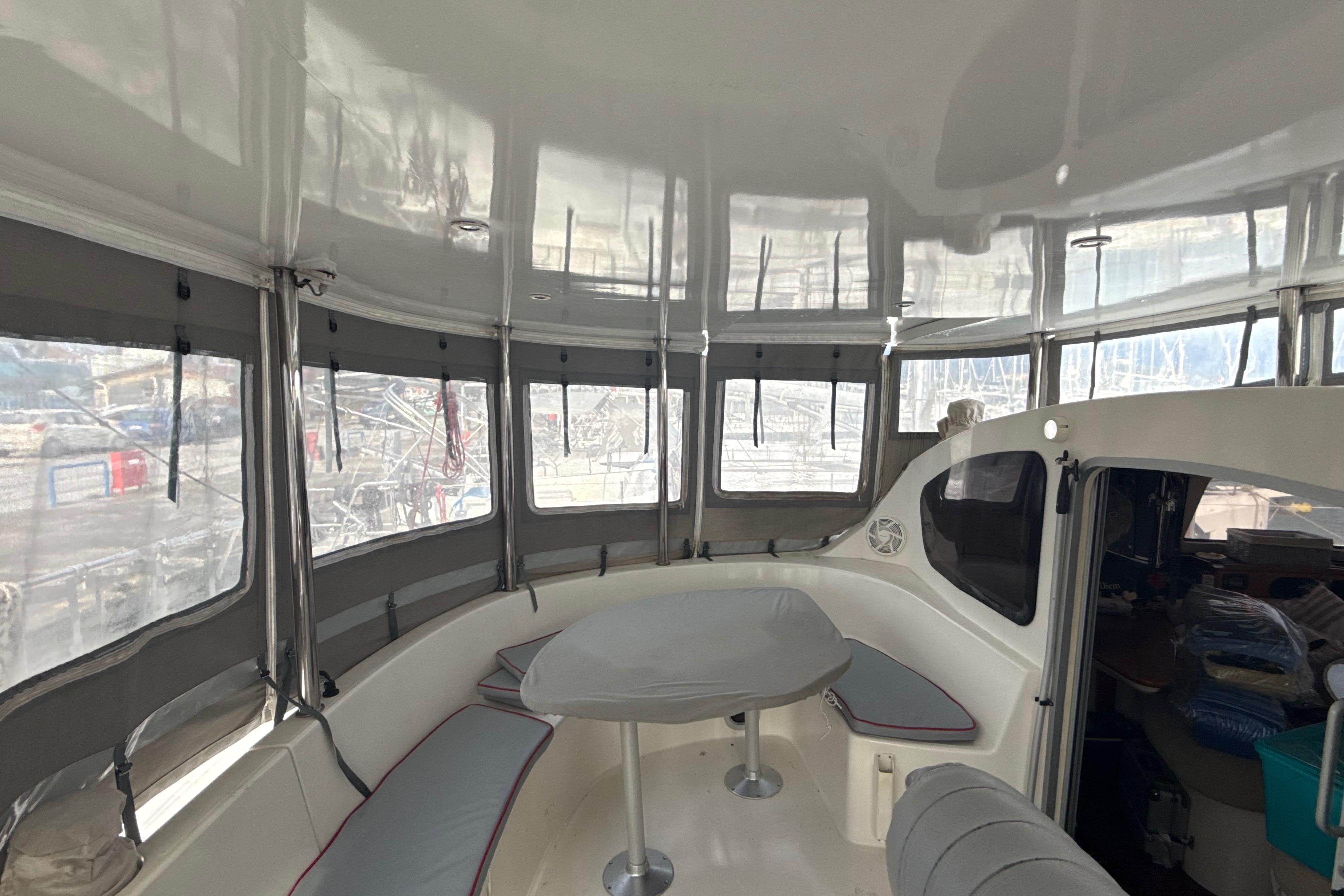Interior of 2003 Fountaine Pajot Belize 43 catamaran with spacious seating and panoramic windows.