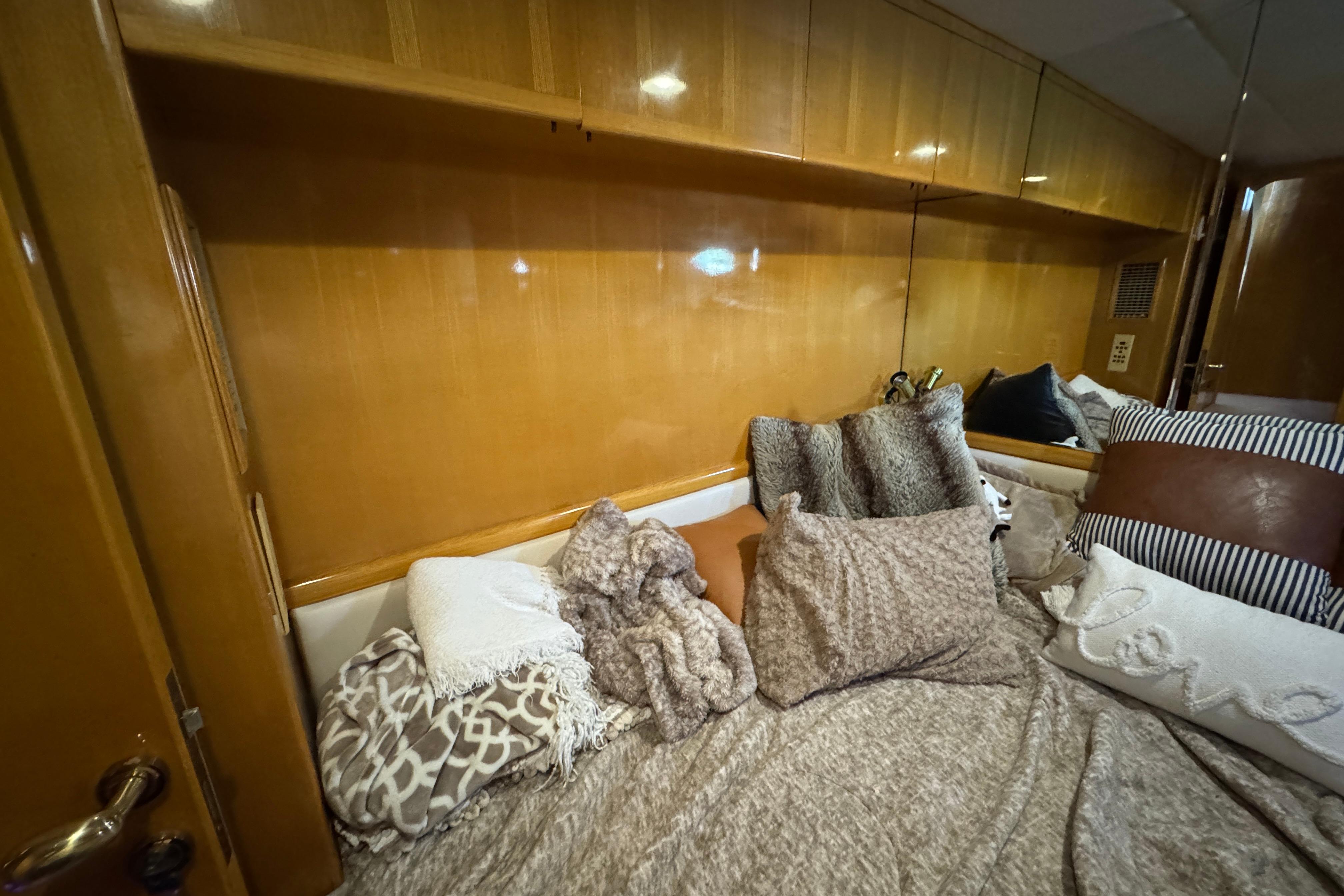 Cozy cabin interior with plush pillows and blankets on a Johnson High-Tech 65 Euro yacht.