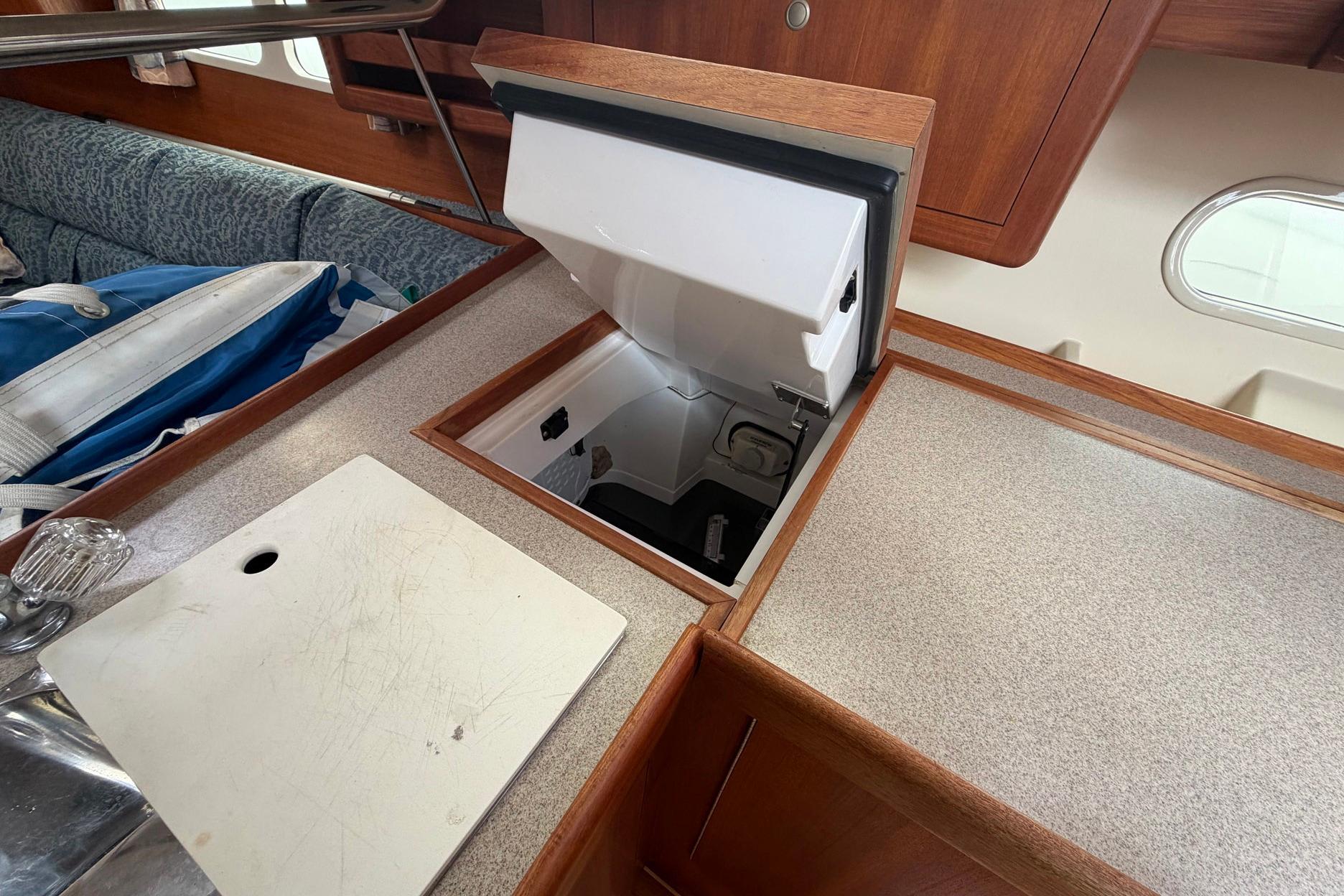 Interior of a 1998 Hunter 410 sailboat featuring a built-in refrigerator.