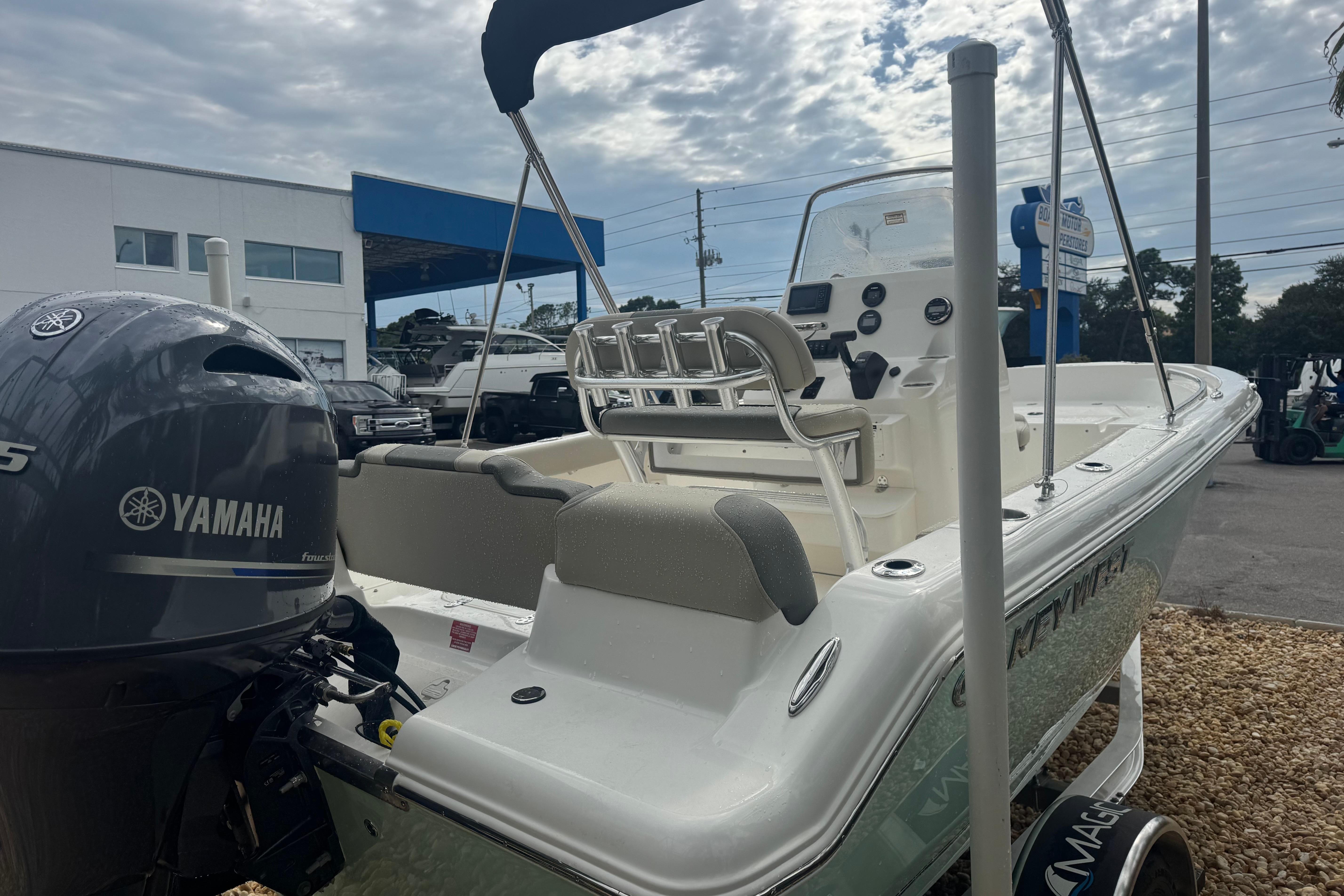 2026 Key West 189 FS boat with Yamaha engine, parked outdoors under cloudy sky.