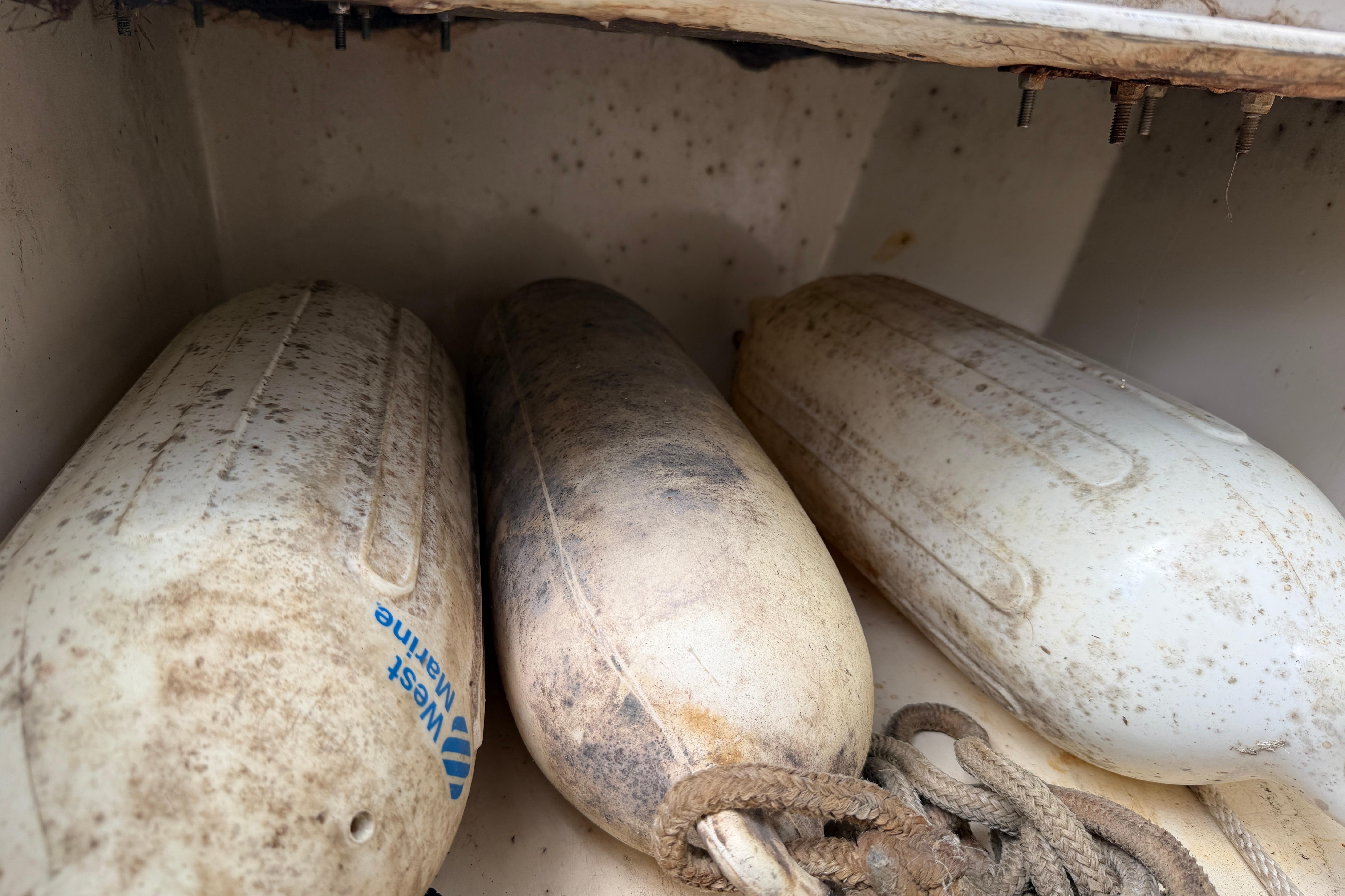 Dirty boat fenders stored in a compartment of a 1987 Grady-White Seafarer 226.