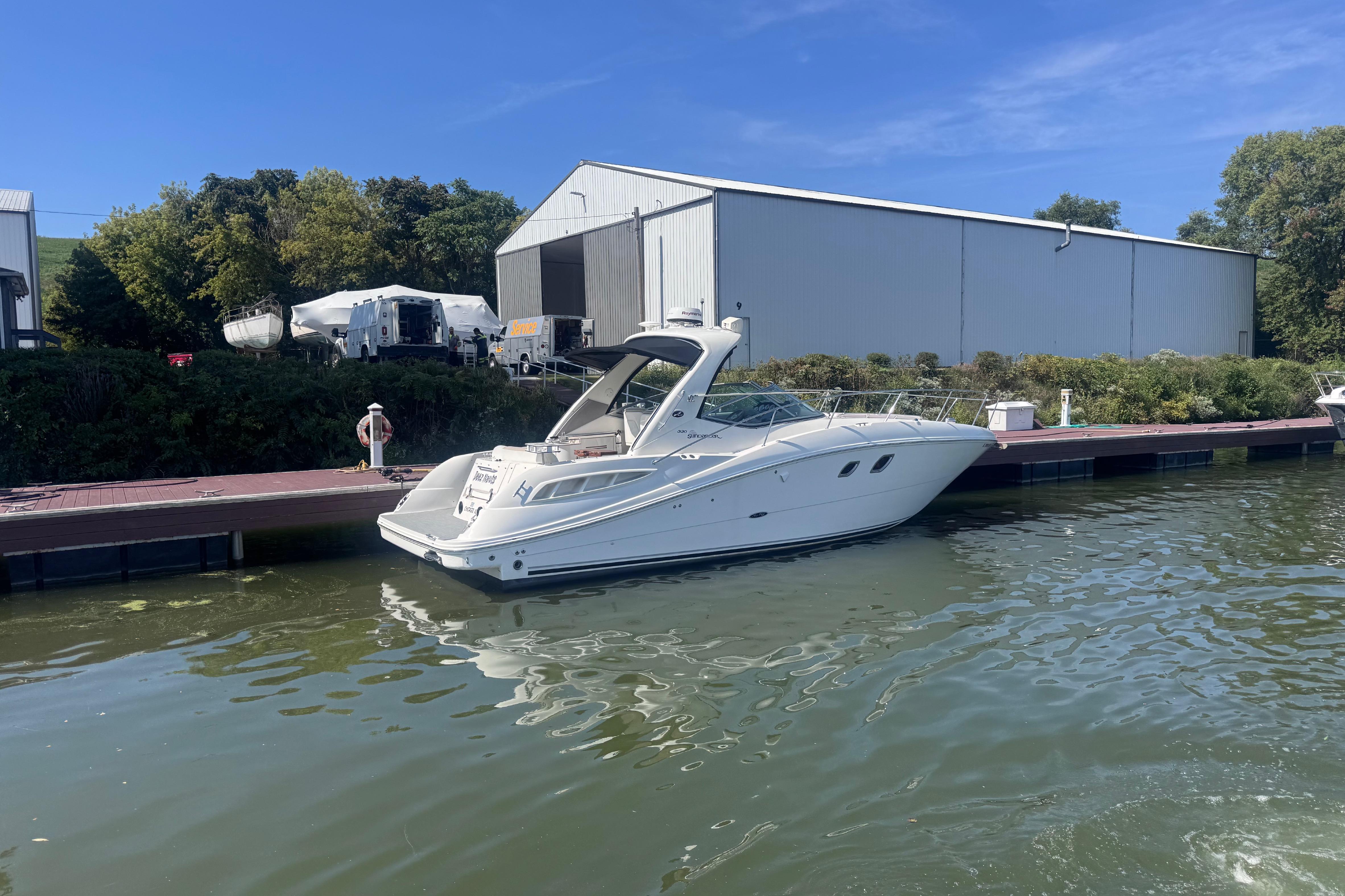 2008 Sea Ray 350 Sundancer docked at marina with blue sky background.