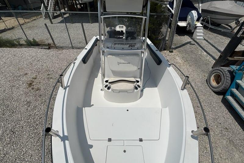 2002 Seaswirl Striper 2101 Center Console O/B boat, docked on gravel surface.