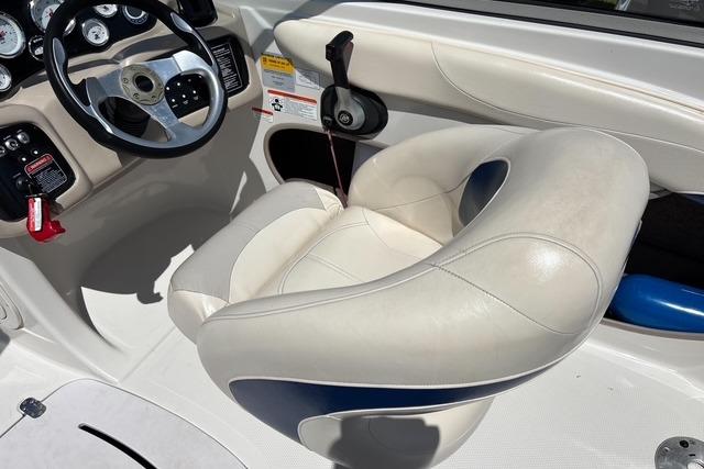 2012 Tahoe Q8 SSi boat interior with steering wheel and cushioned seat.