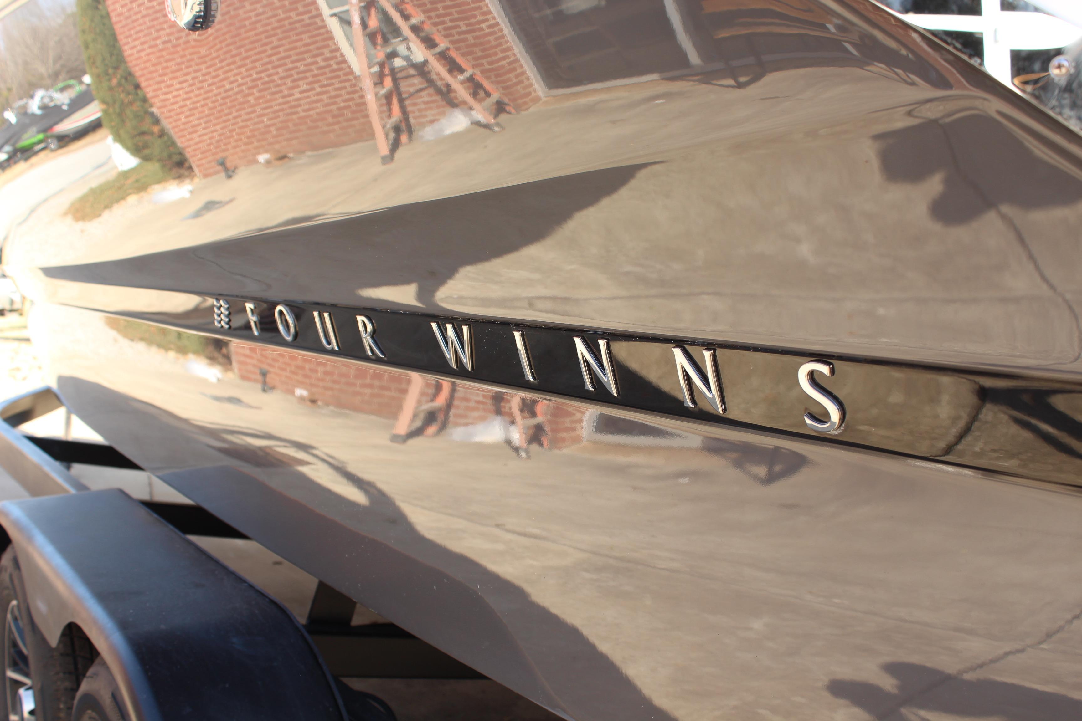 2026 Four Winns H4 boat exterior with reflective finish and logo.