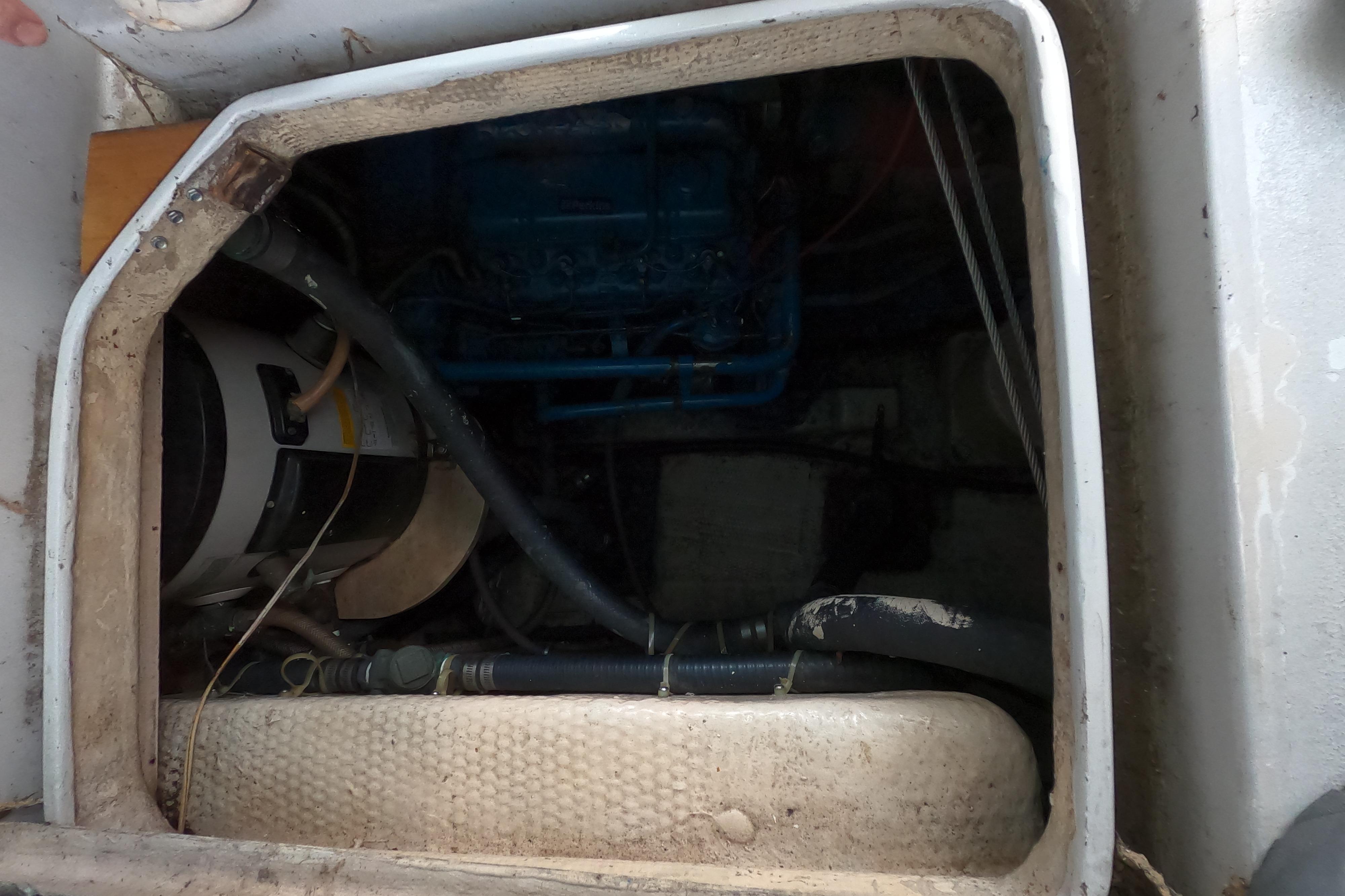 Engine compartment of a 1978 CSY 44 sailboat, showing mechanical components and wiring.