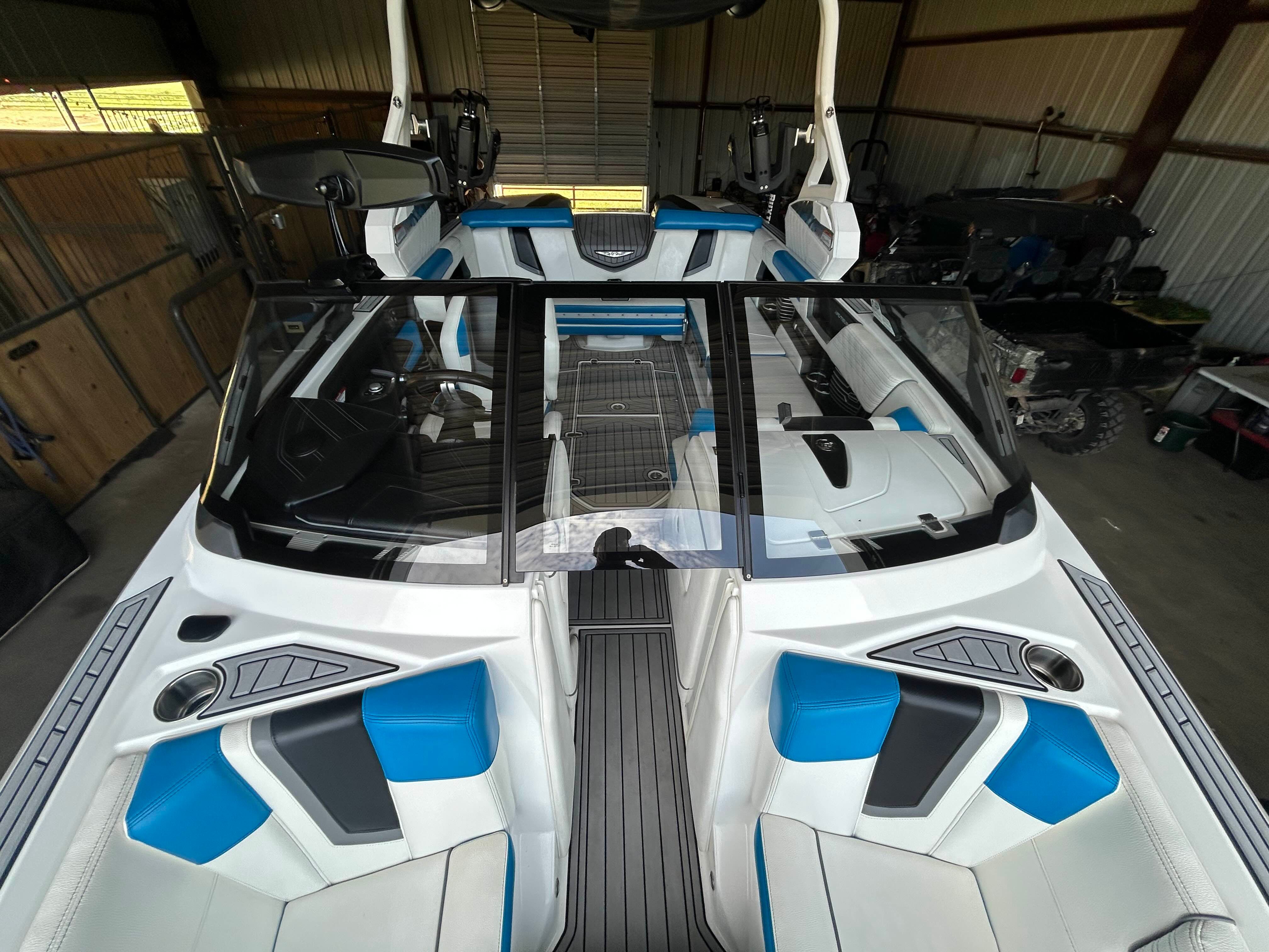 The image shows the interior of a 2019 Nautique G23 boat with blue and white seating.