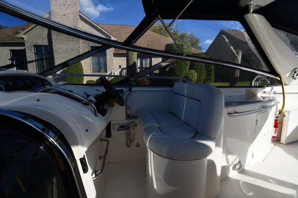 Interior view of 1997 Sunseeker Camargue 47 yacht with white seating and steering area.