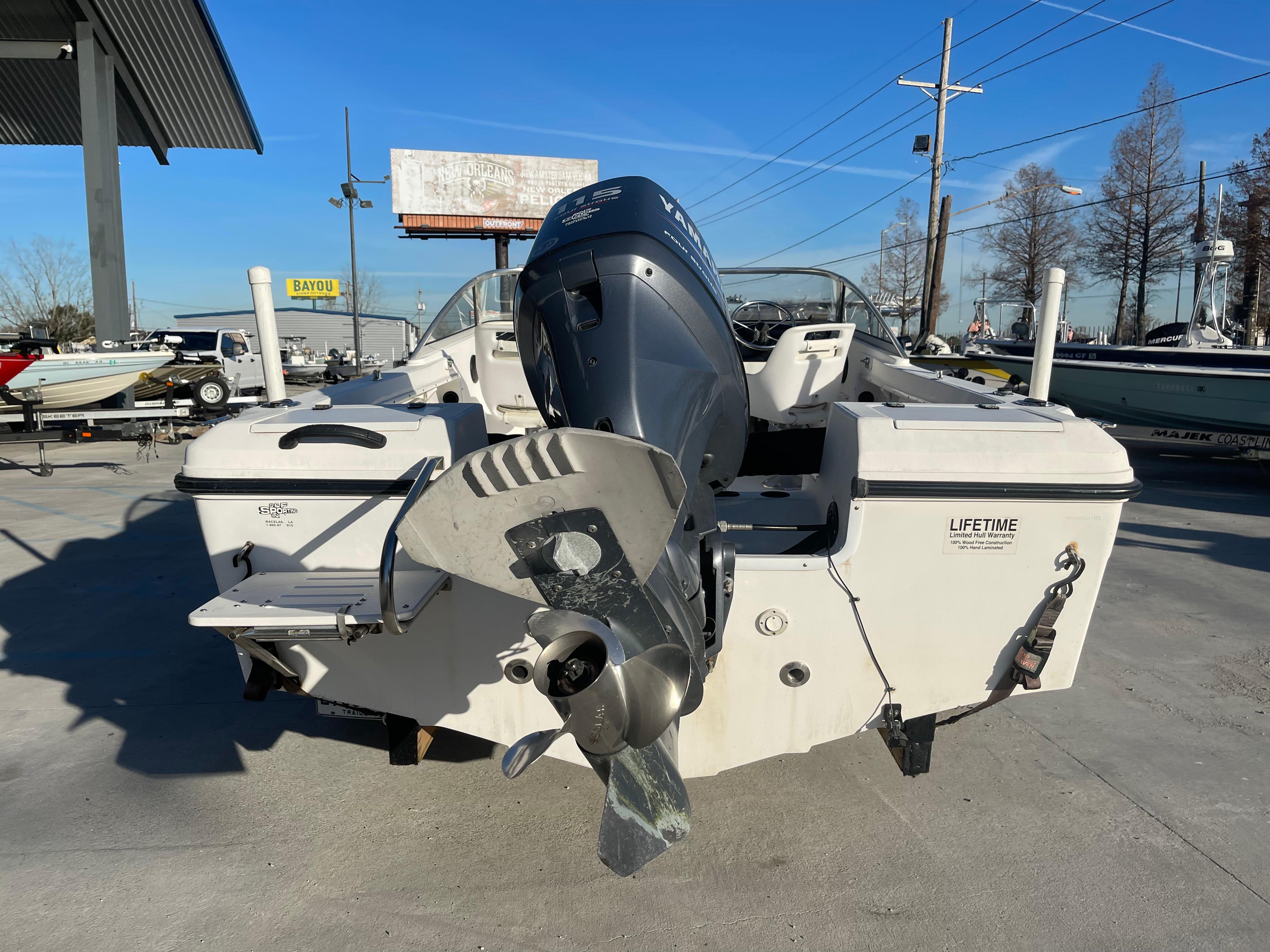 2002 Angler 18 DC boat with outboard motor, displayed outdoors on a sunny day.