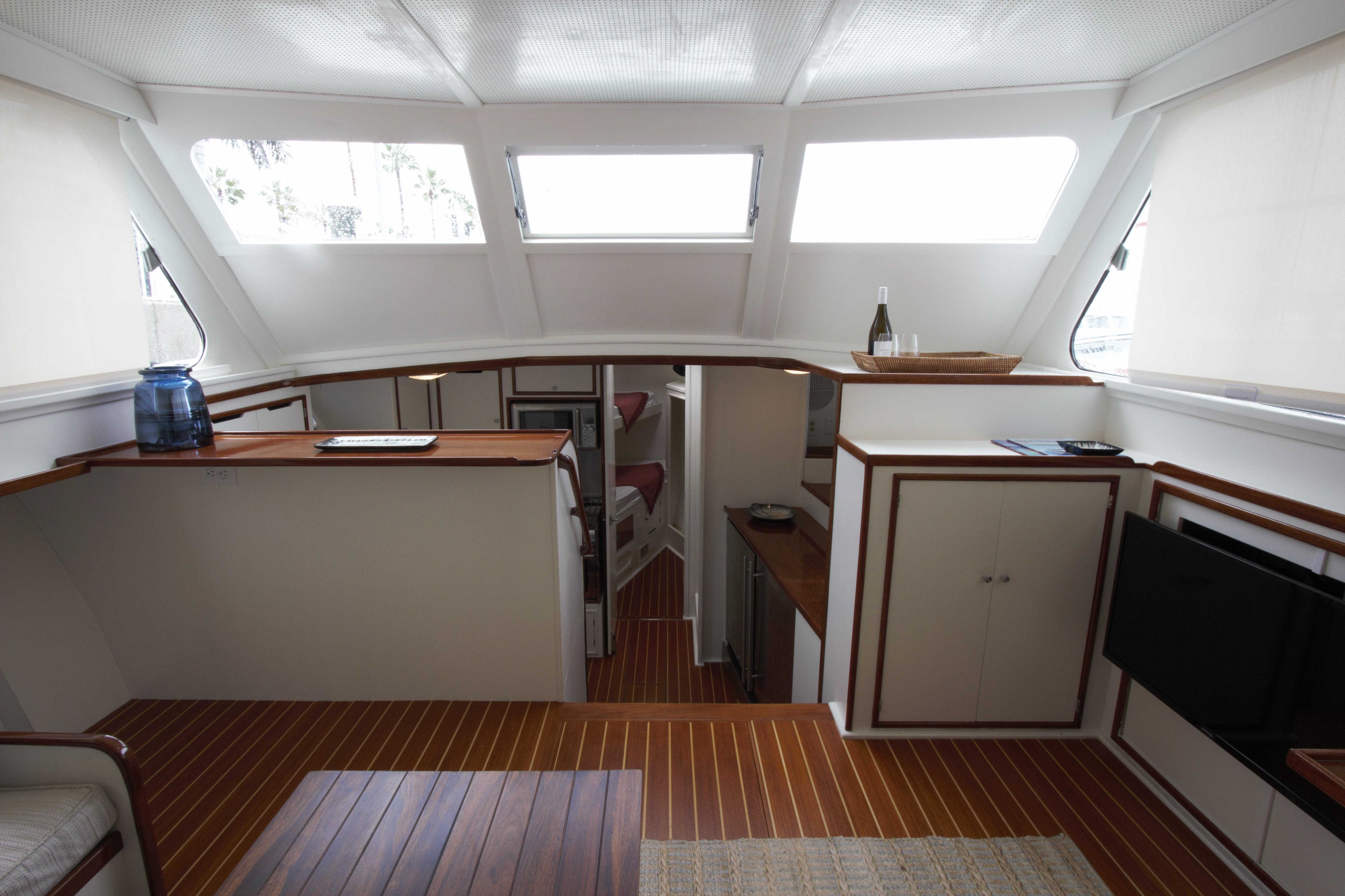 Interior of a 1963 Huckins Linwood yacht with wood flooring and modern amenities.